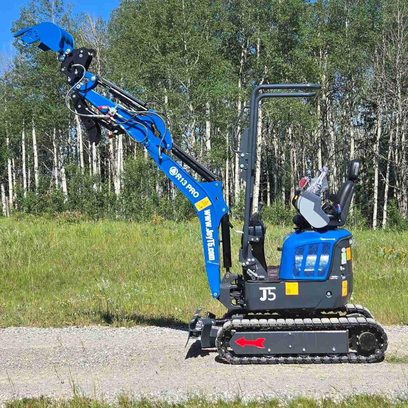Rippa R13 mini excavator for sale by JoyT5 on a grassy area with trees in the background