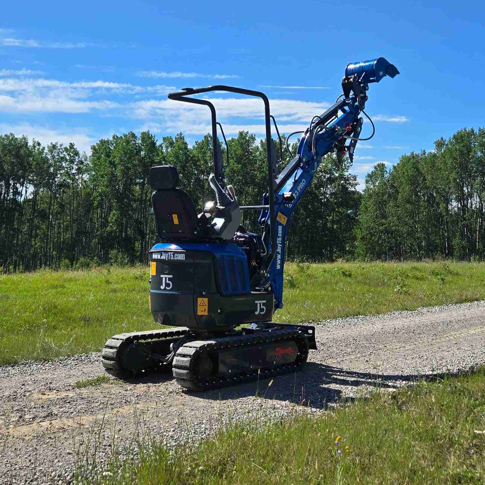 Rippa R13 mini excavator for sale by JoyT5 on a gravel path with trees and blue sky in the background