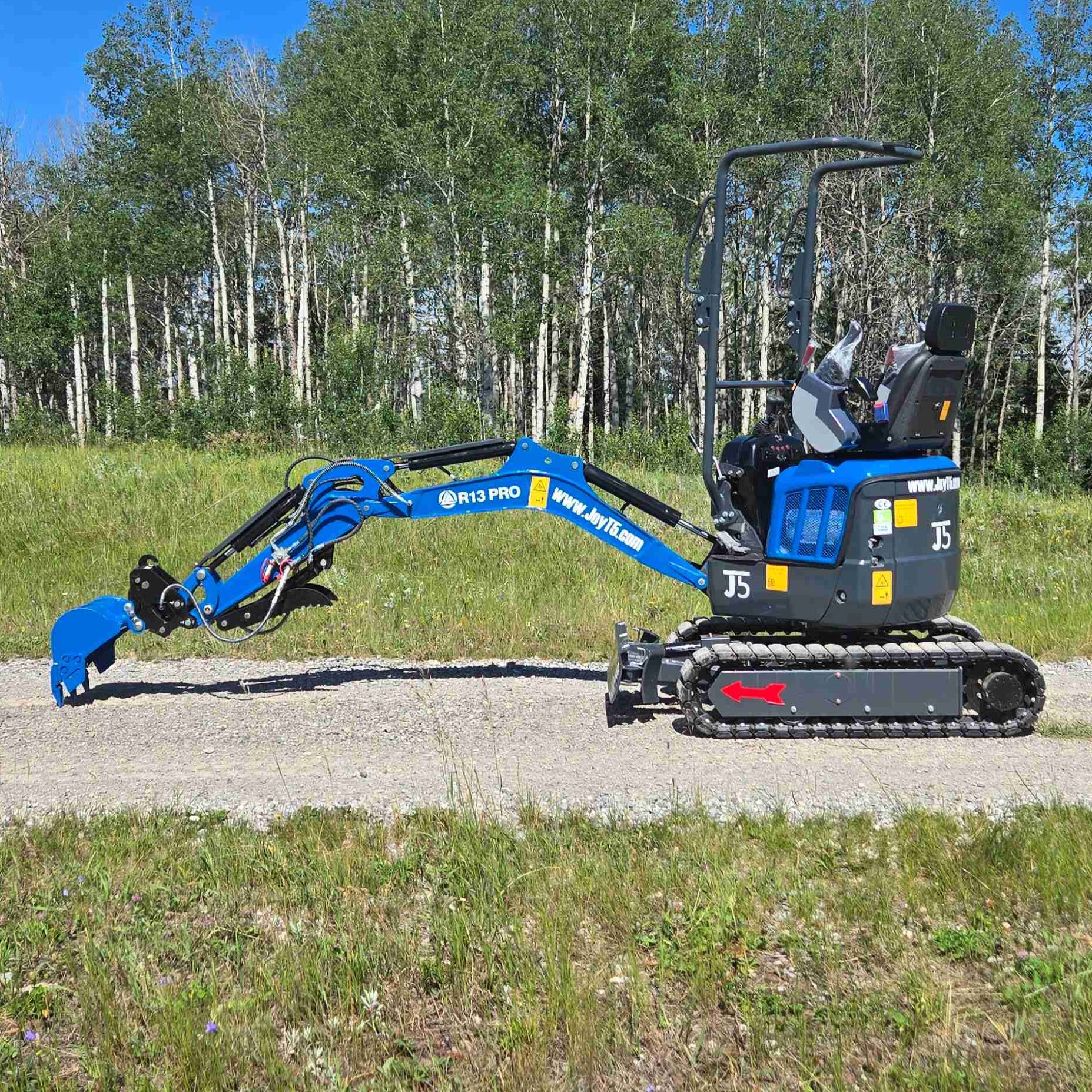 Rippa R13 mini excavator for sale by JoyT5 on a gravel road with trees in the background