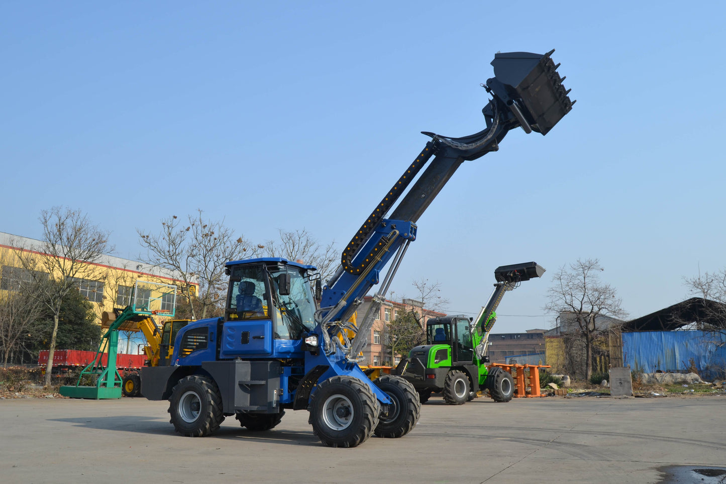 Blue wheel loader with extended telescopic arm and raised bucket for high reach loading operations