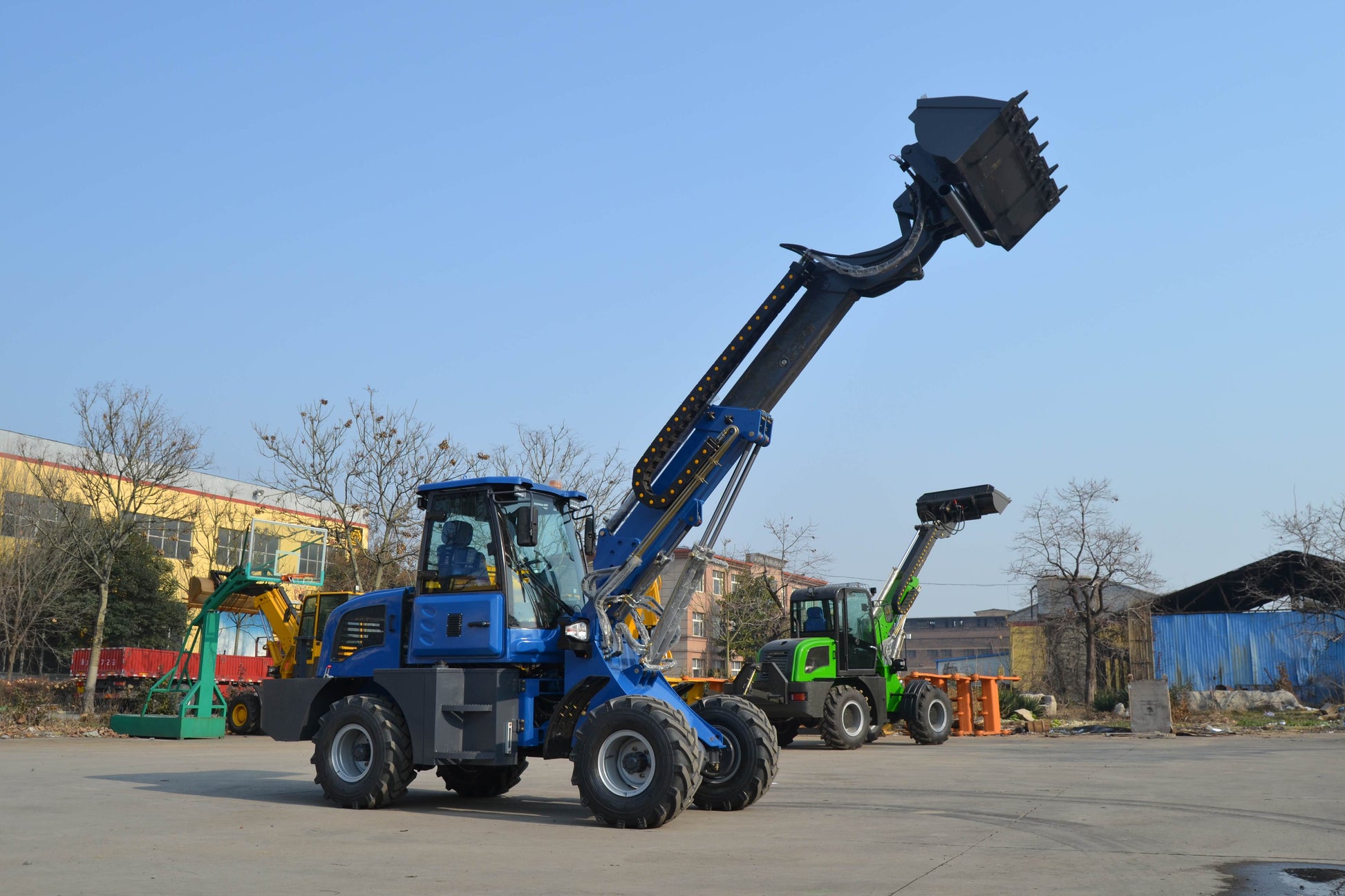 Blue wheel loader with extended telescopic arm and raised bucket for high reach loading operations