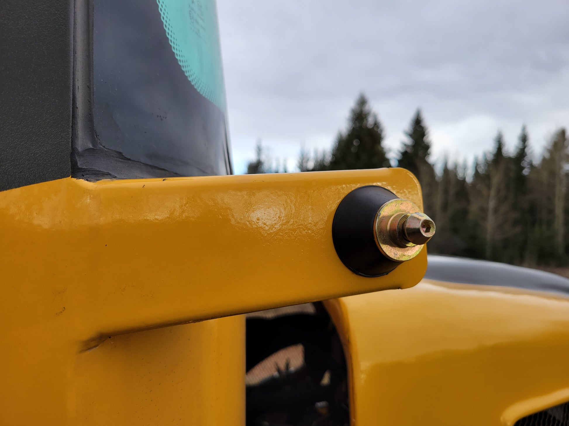 JT5WL1200 Compact Wheel Loader 1.2 Ton for Sale in Canada close up of mirror or light mounting bracket showing durable metal design for construction and snow removal use