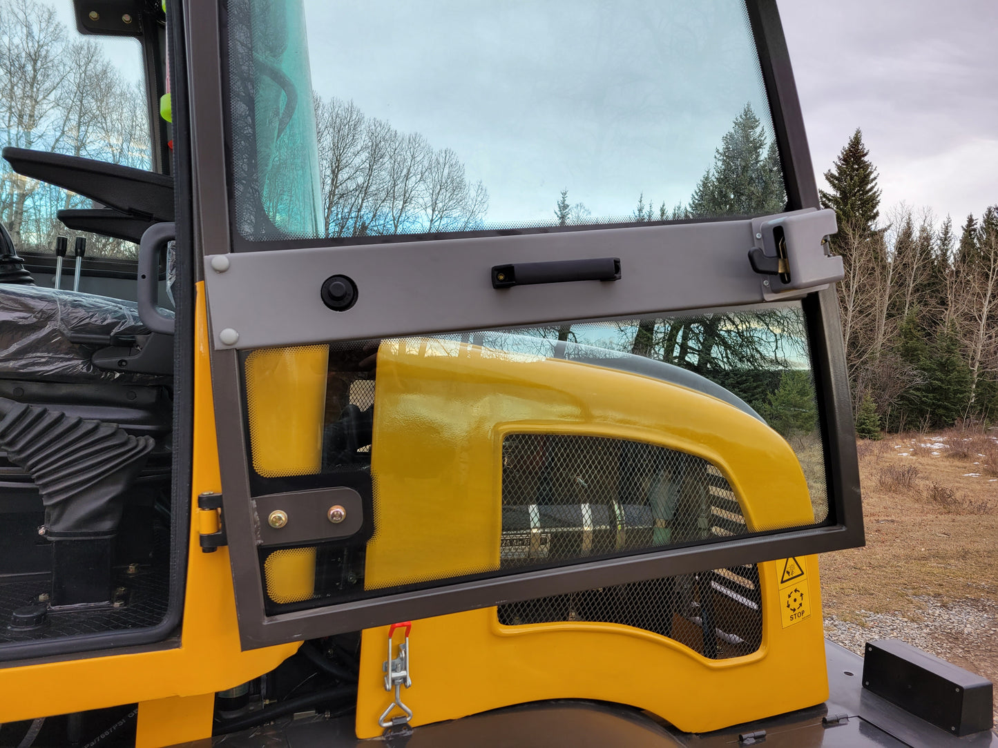 JT5WL1200 Compact Wheel Loader 1.2 Ton for Sale in Canada showing open side cabin door with ventilation design for operator comfort and easy access during snow removal and construction