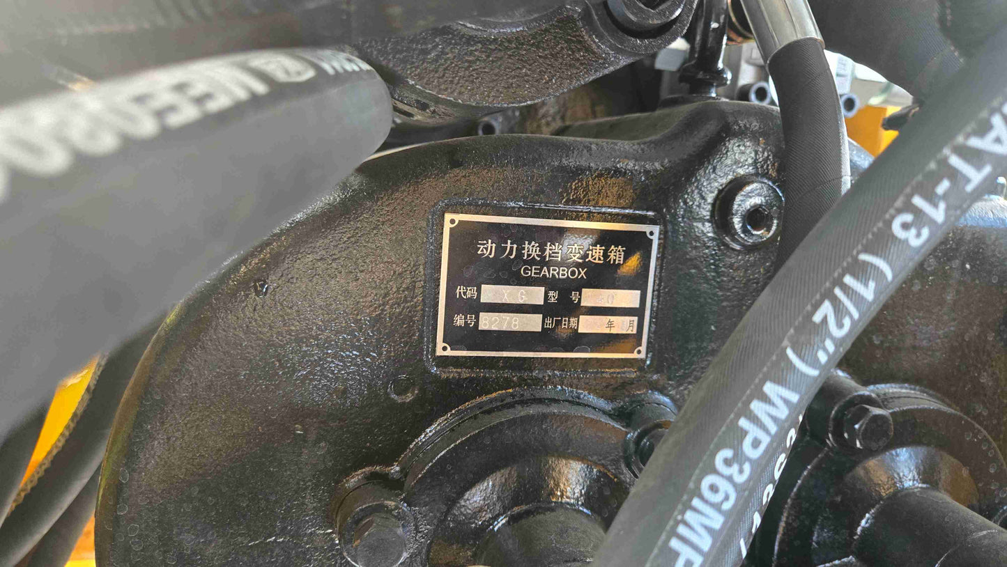 Compact Wheel Loader JT5WL1500 1.5 Ton for Sale in Canada close up of gearbox assembly with hydraulic hoses showing durable power transmission for snow removal and construction use