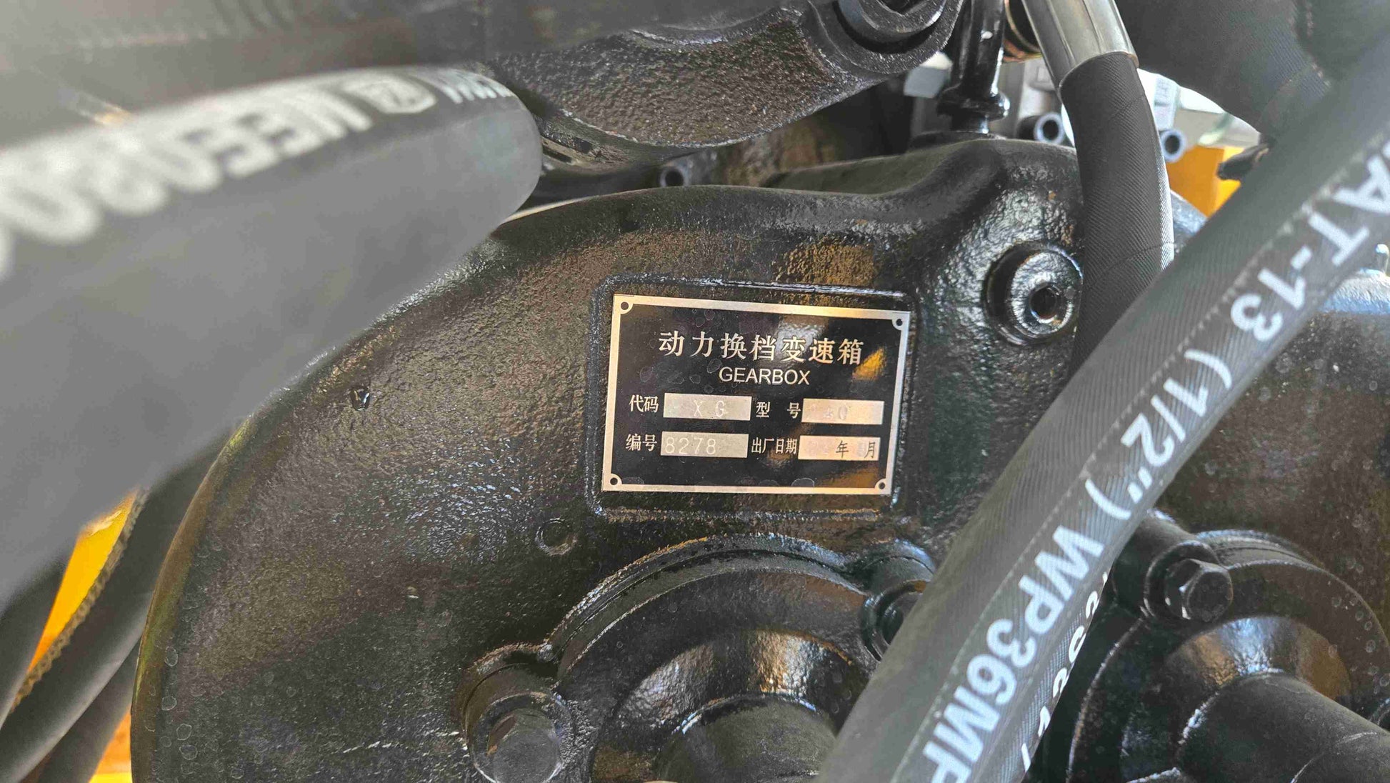 Compact Wheel Loader JT5WL1500 1.5 Ton for Sale in Canada close up of gearbox assembly with hydraulic hoses showing durable power transmission for snow removal and construction use