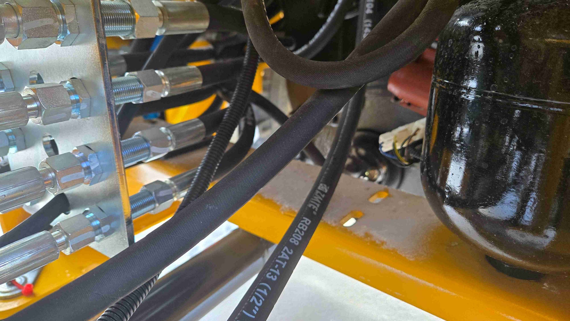 Compact Wheel Loader JT5WL1500 1.5 Ton for Sale in Canada showing hydraulic connection fittings and pressure tank system for reliable snow removal and construction performance