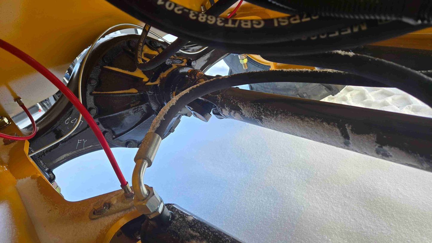 Compact Wheel Loader JT5WL1500 1.5 Ton for Sale in Canada close up of rear axle and drivetrain system with hydraulic connections for reliable snow removal and construction performance