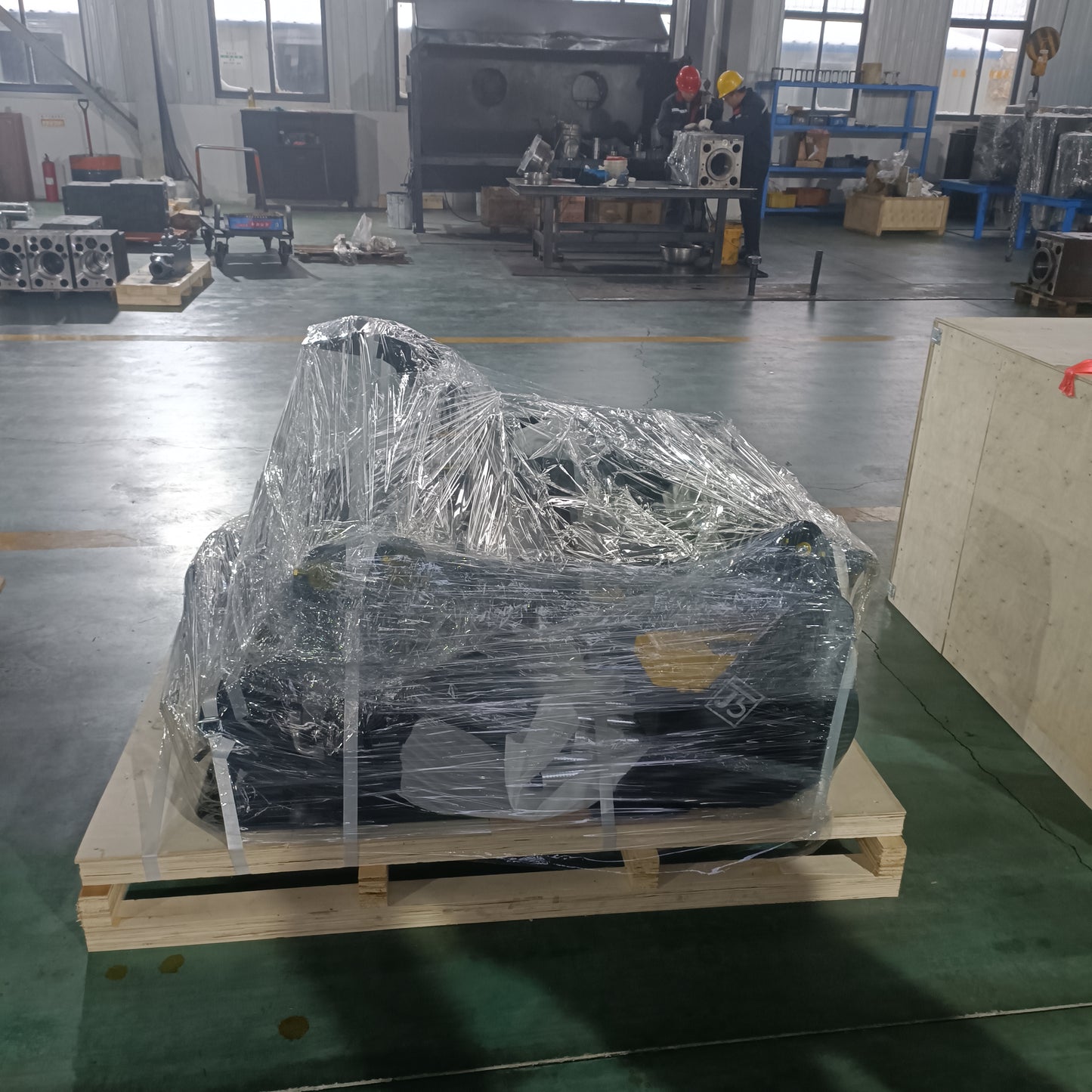 custom excavator attachments made in Canada securely packaged for shipping including heavy duty bucket and grapple for construction equipment