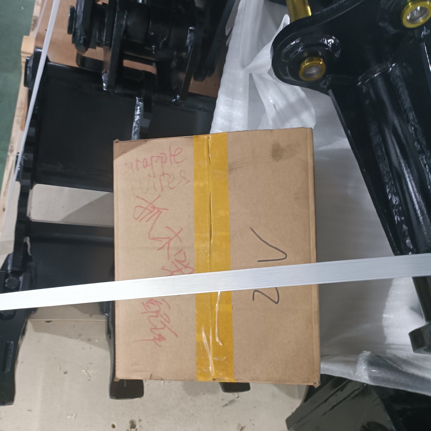 custom excavator grapple attachment packed for shipping made in Canada heavy duty construction equipment ready for delivery

