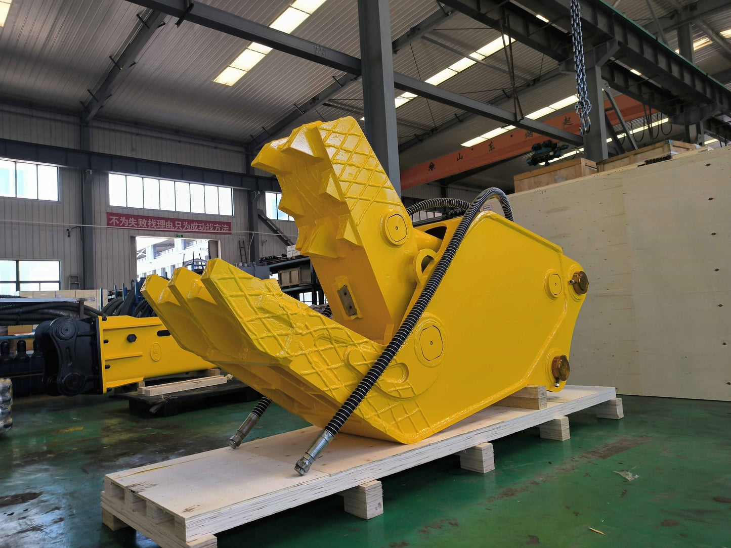 Excavator hydraulic concrete pulverizer attachment made in Canada used for crushing reinforced concrete and stone in demolition and recycling projects