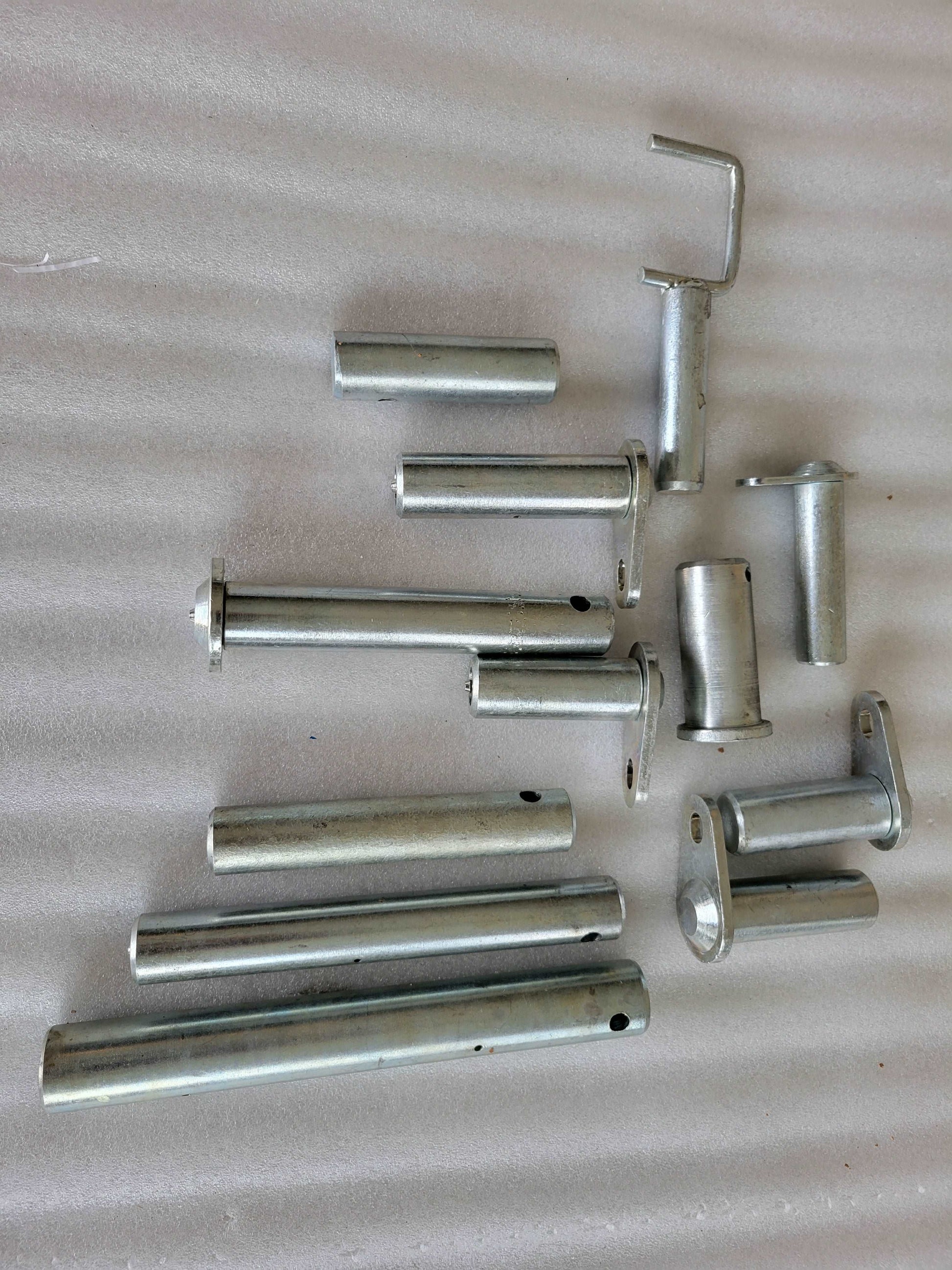 Steel pins and bushings set for excavator and loader replacement parts used in heavy equipment maintenance in Canada