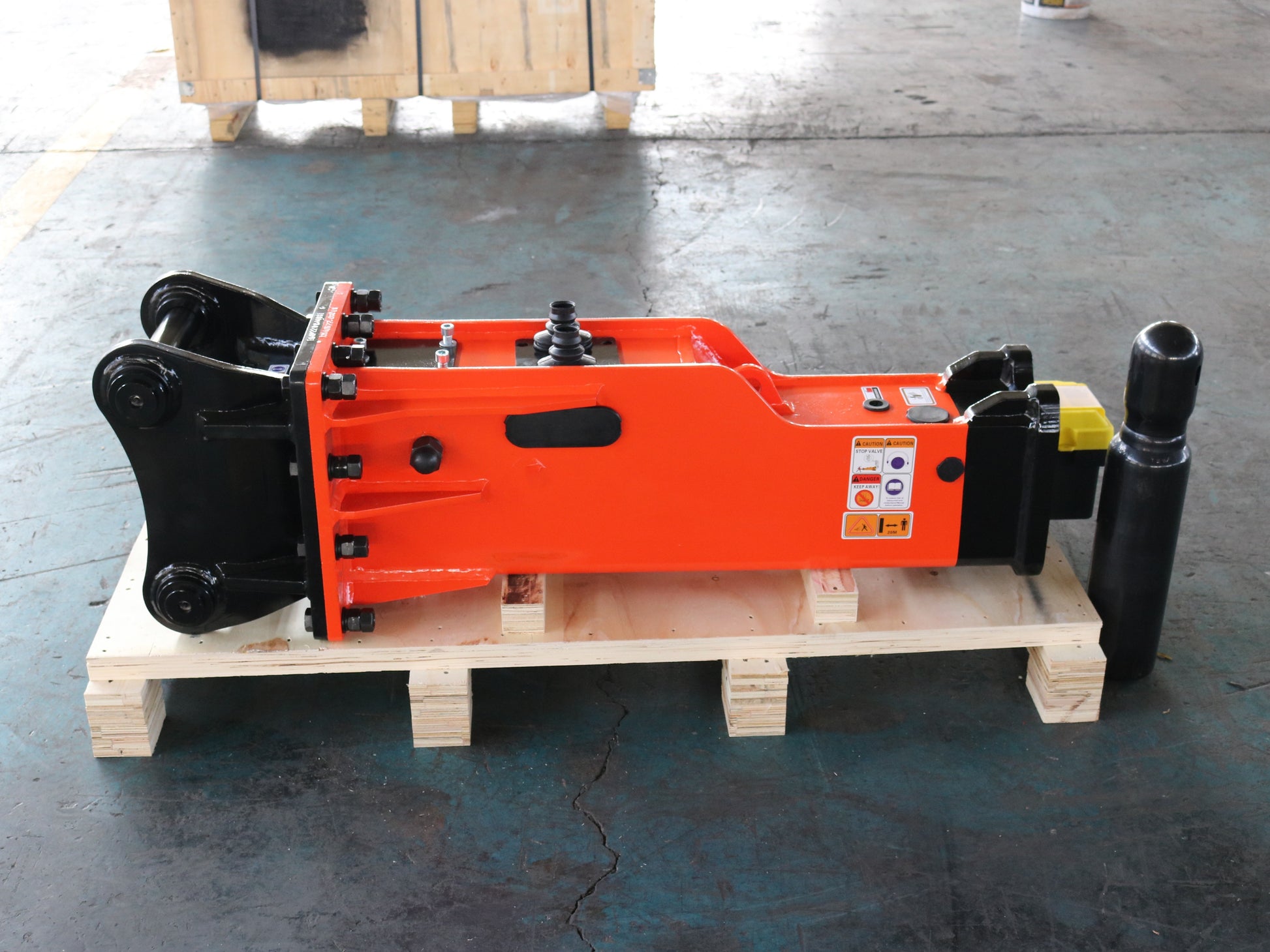 Hydraulic breaker hammer for excavators Canada and USA showing red heavy duty breaker attachment on pallet ready for demolition excavation and construction use.