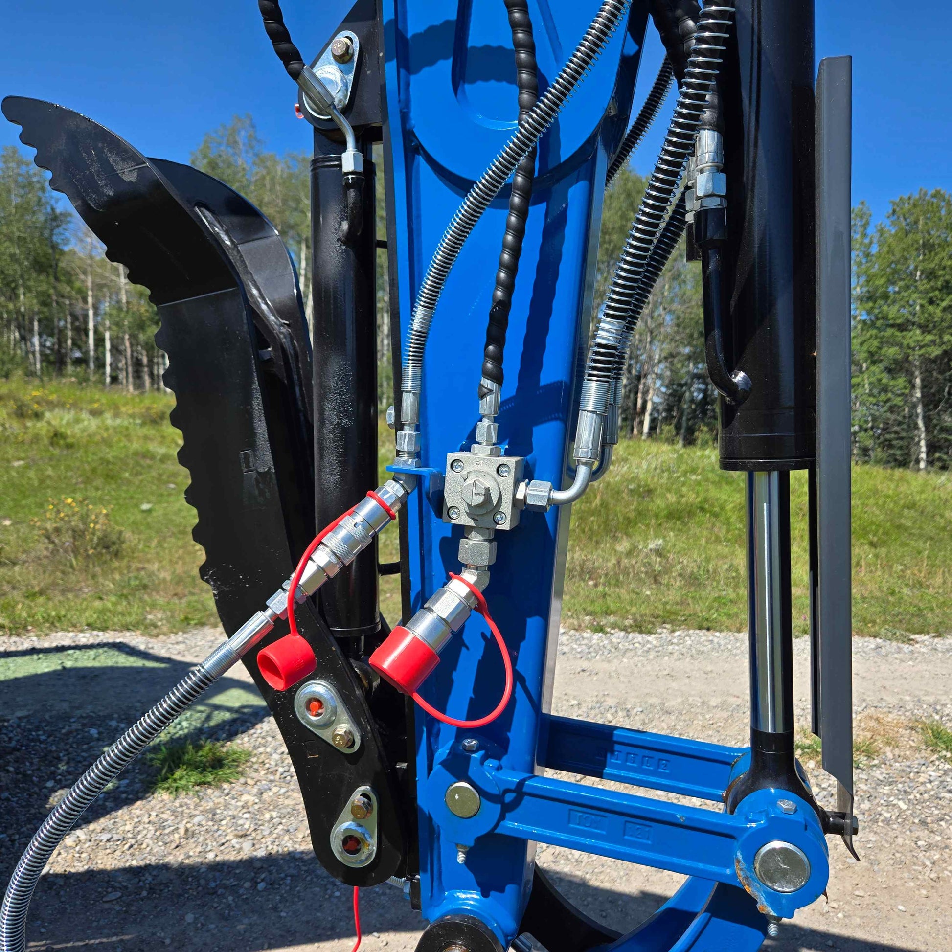 Hydraulic thumb and hoses on a JoyT5 excavator arm working in Canada