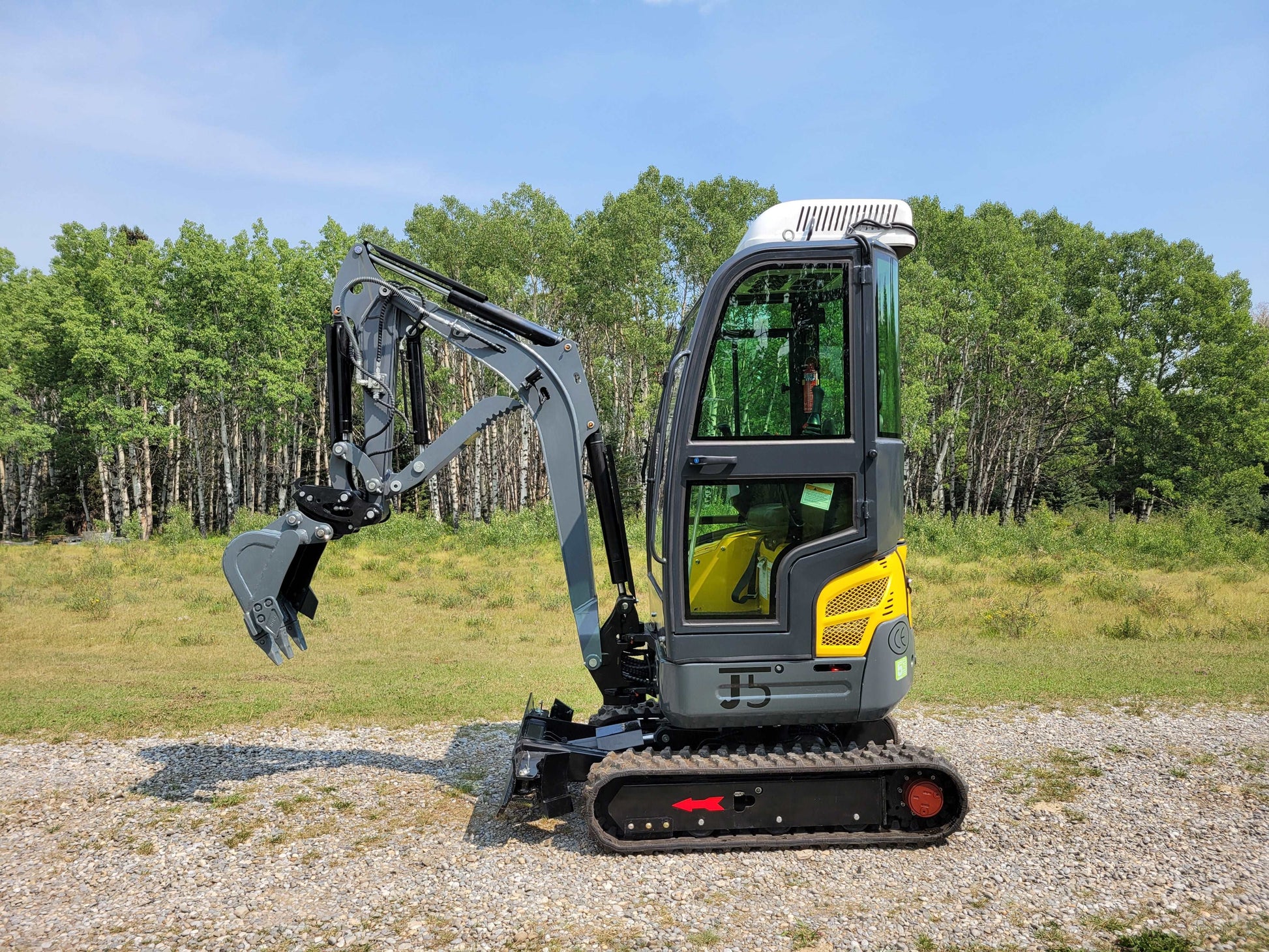 Side view of JoyT5 JT5200 2 Ton Mini Excavator for Rent in Calgary, full cab compact excavator hire Alberta for landscaping and construction