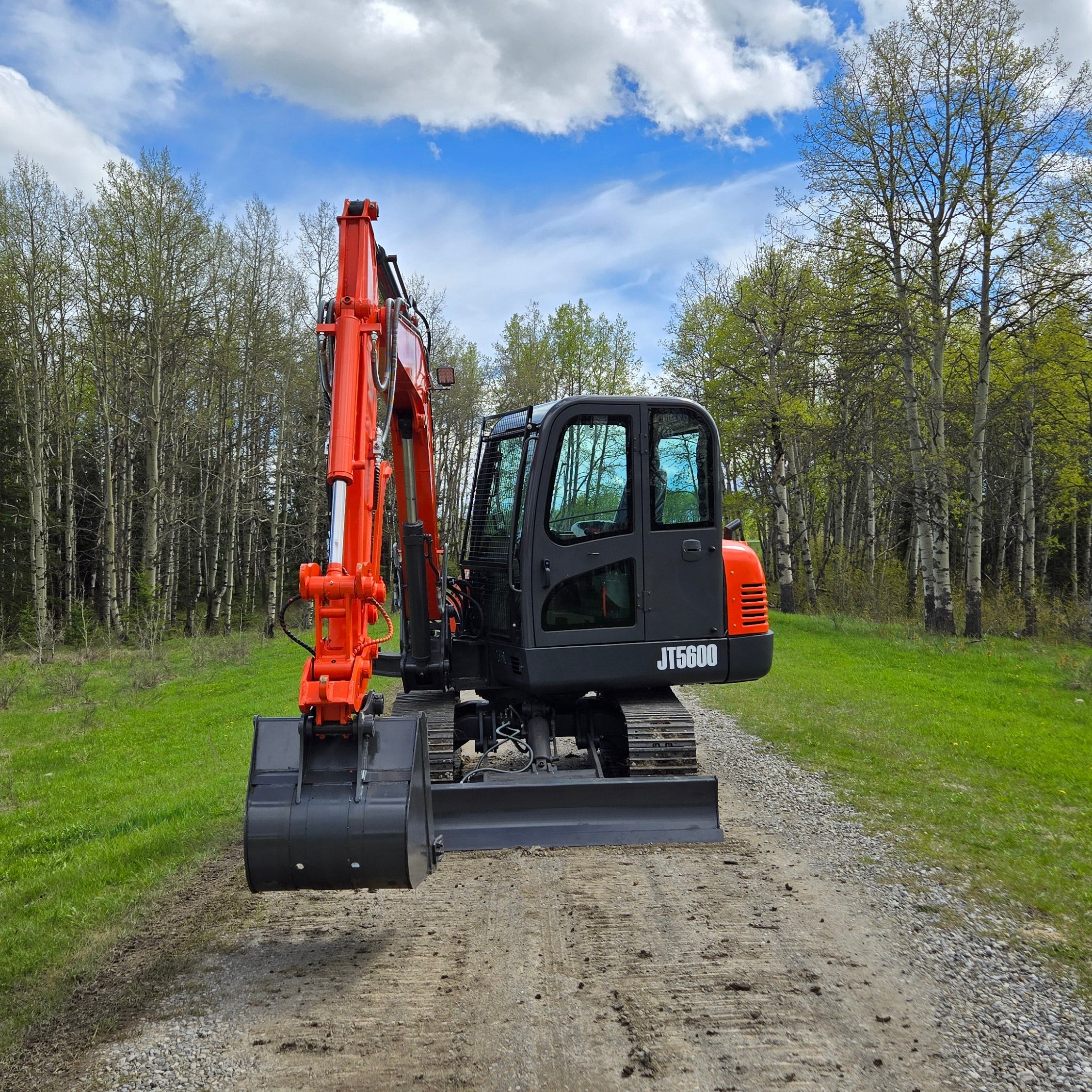 JoyT5 JT5600 6 ton mini excavator for sale in Canada front left working view with Yanmar diesel engine full cab compact excavator with hydraulic bucket for construction excavation and landscaping work across Canada and USA