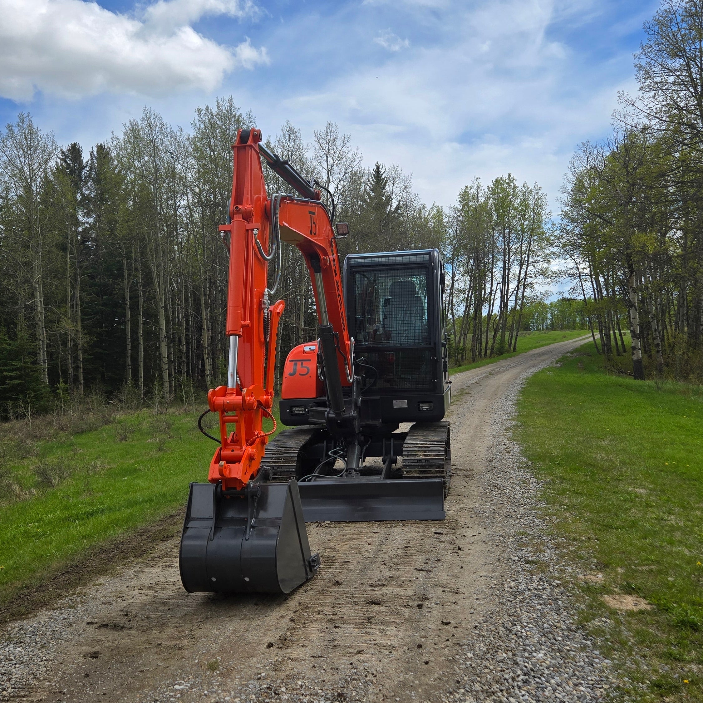 JoyT5 JT5600 6 ton mini excavator for sale in Canada rear working view with bucket lowered to ground Yanmar diesel engine full cab compact excavator for construction digging trenching and site work in Canada and USA