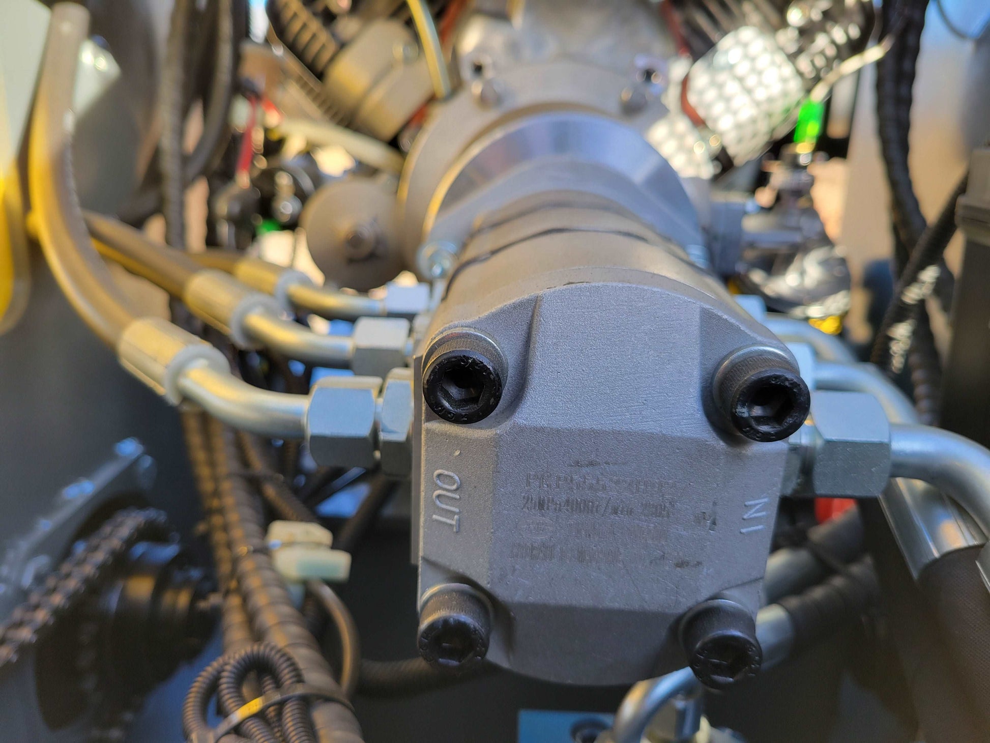 Close-up of the hydraulic pump with IN and OUT ports on JoyT5 JT5SSTM3 mini skid steer loader