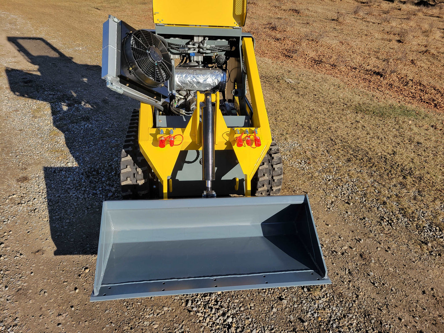 Front view of JoyT5 JT5SSTM3 mini skid steer with open hydraulic system and bucket attachment | compact tracked loader for landscaping and material handling