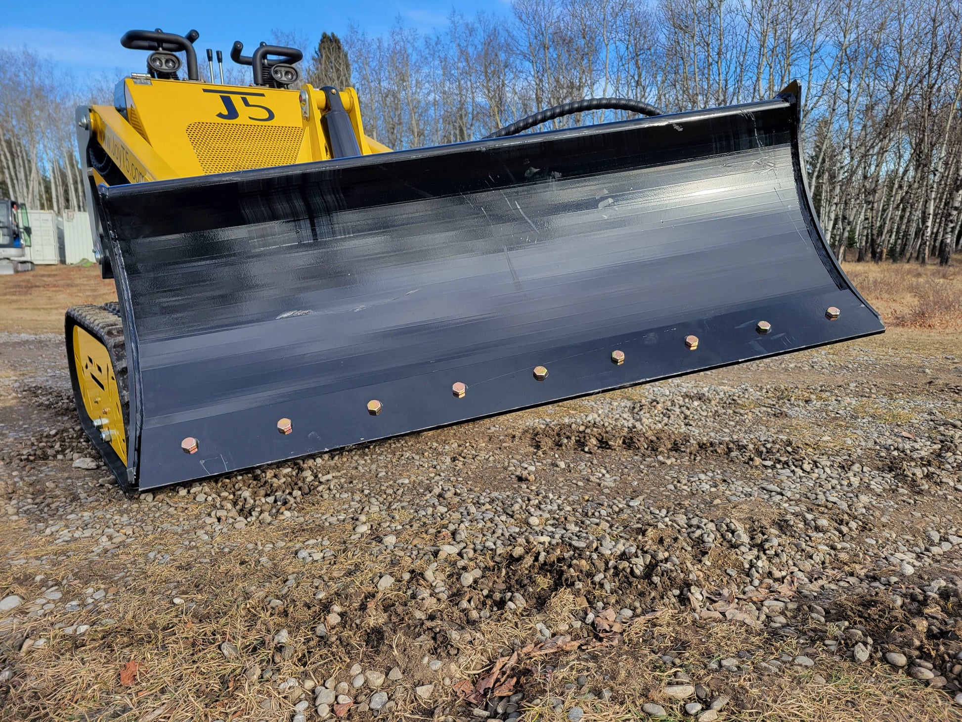 JoyT5 JT5SSTM3 mini skid steer with heavy-duty snow and dirt blade attachment, compact tracked skid steer loader for landscaping and snow removal in Canada.