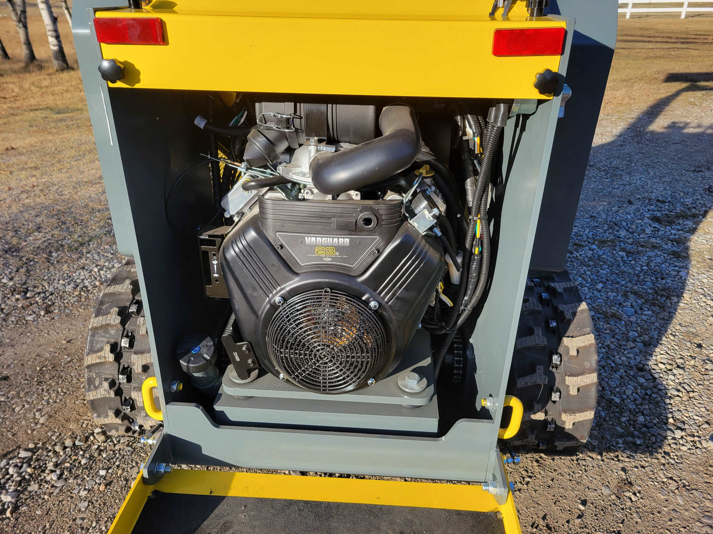JoyT5 JT5SSTM3 mini tracked skid steer rear engine view showing 23 HP gasoline engine for construction landscaping and material handling use in Canada