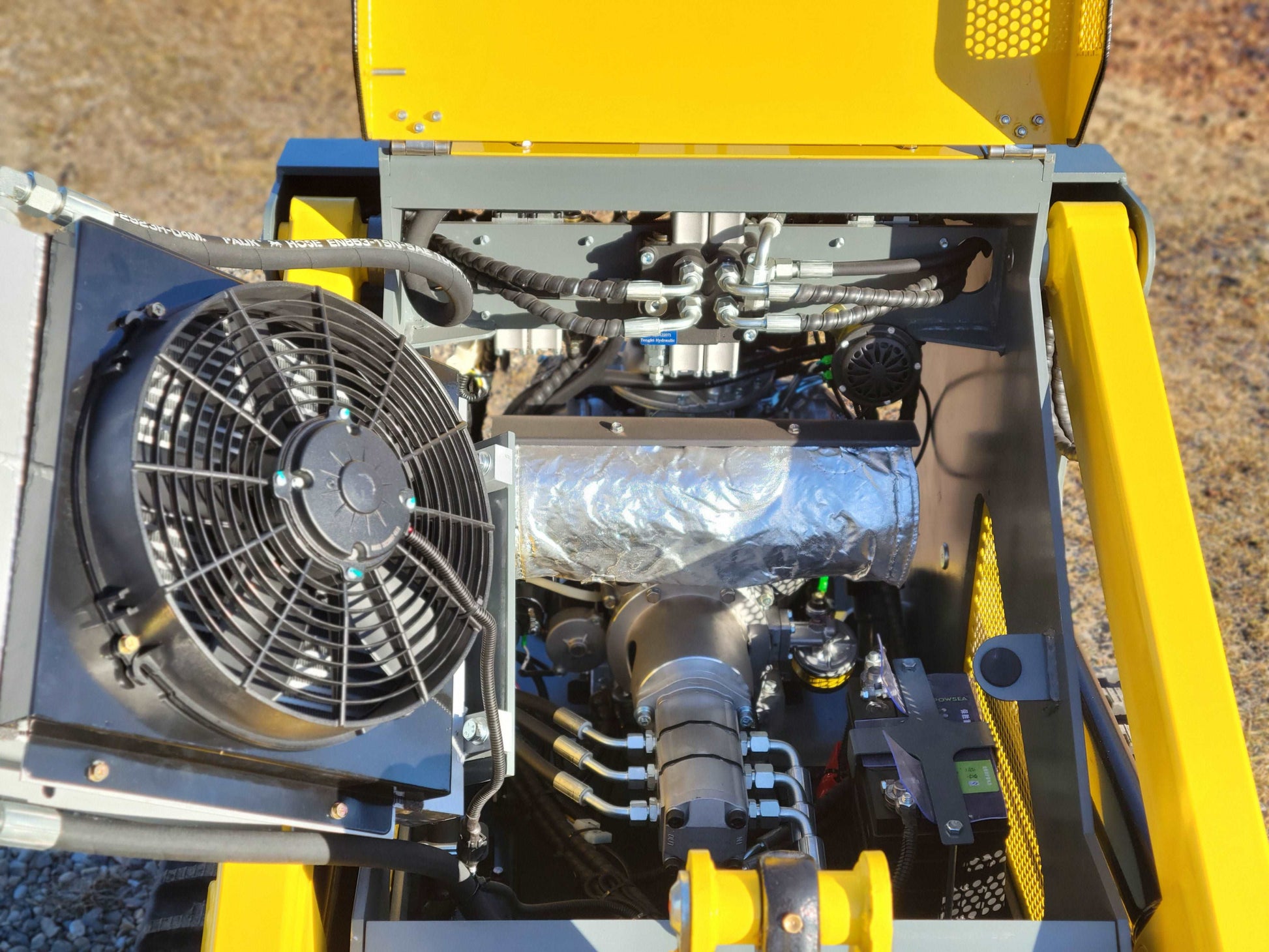 JoyT5 JT5SSTM3 mini tracked skid steer open engine compartment showing cooling fan radiator and hydraulic system for compact loader performance in Canada