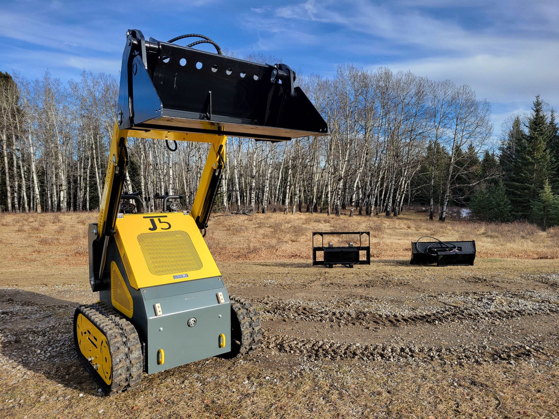 JoyT5 JT5SSTM3 mini tracked skid steer shown from front view with raised bucket demonstrating lifting height for construction landscaping and agriculture jobs in Canada