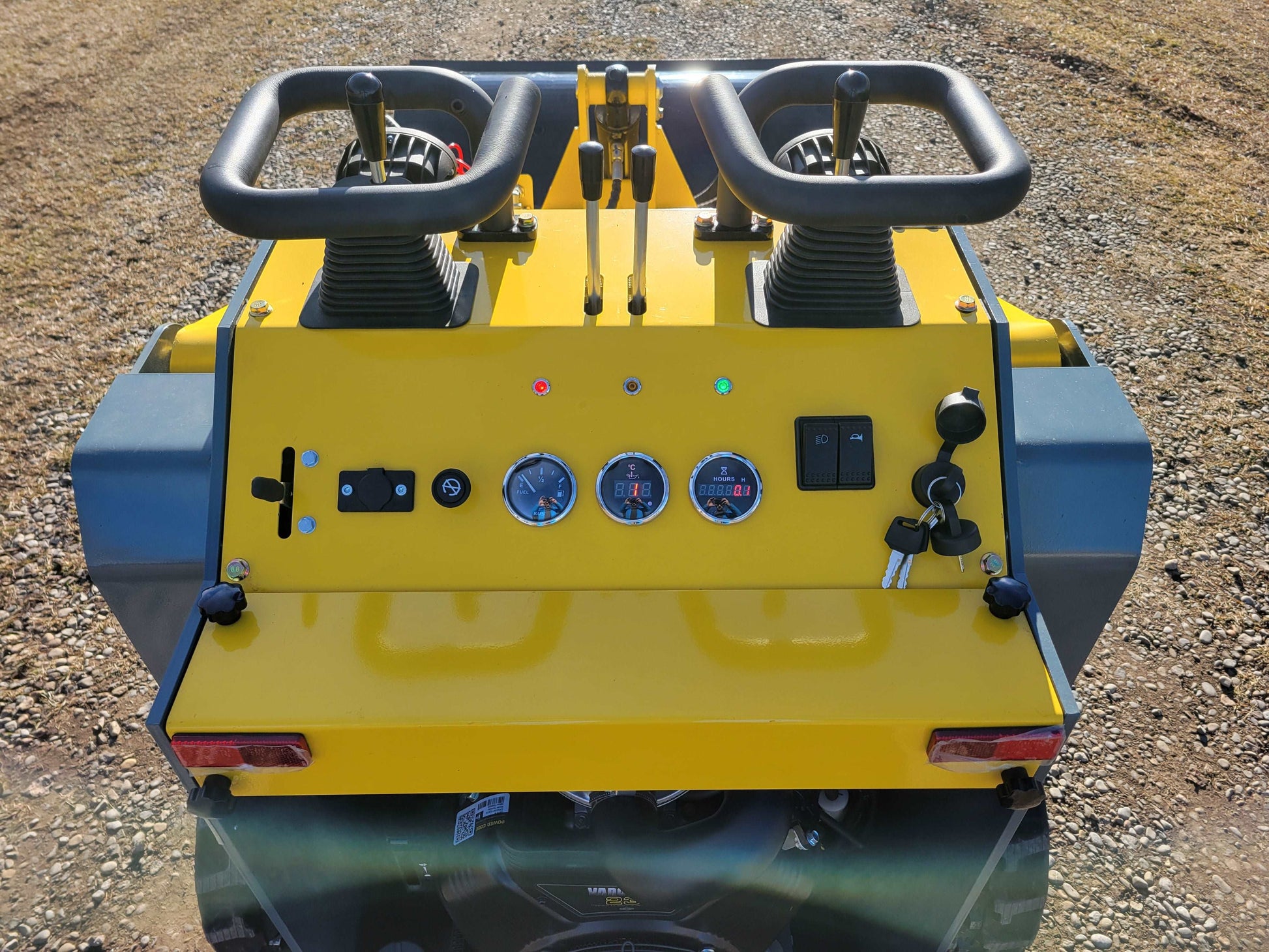 JoyT5 JT5SSTM3 mini tracked skid steer operator control panel showing dual hand controls gauges and ignition system for construction and landscaping work in Canada