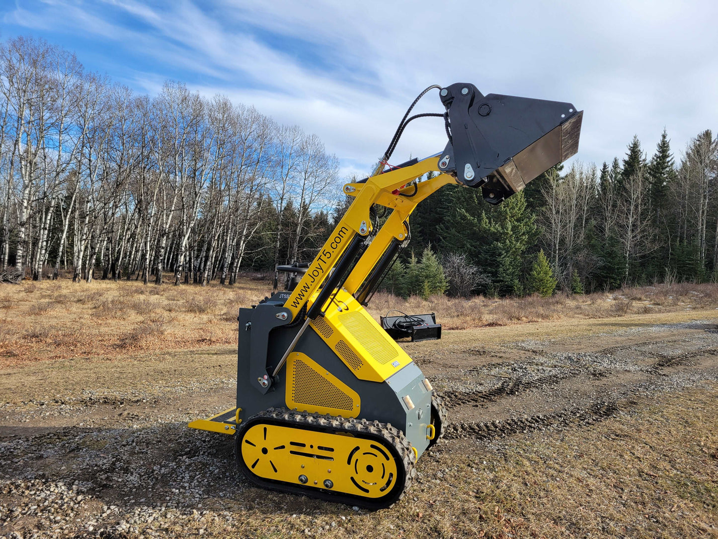 JoyT5 JT5SSTM3 mini tracked skid steer shown from side view with raised loader arm demonstrating lift height for construction landscaping and agriculture work in Canada