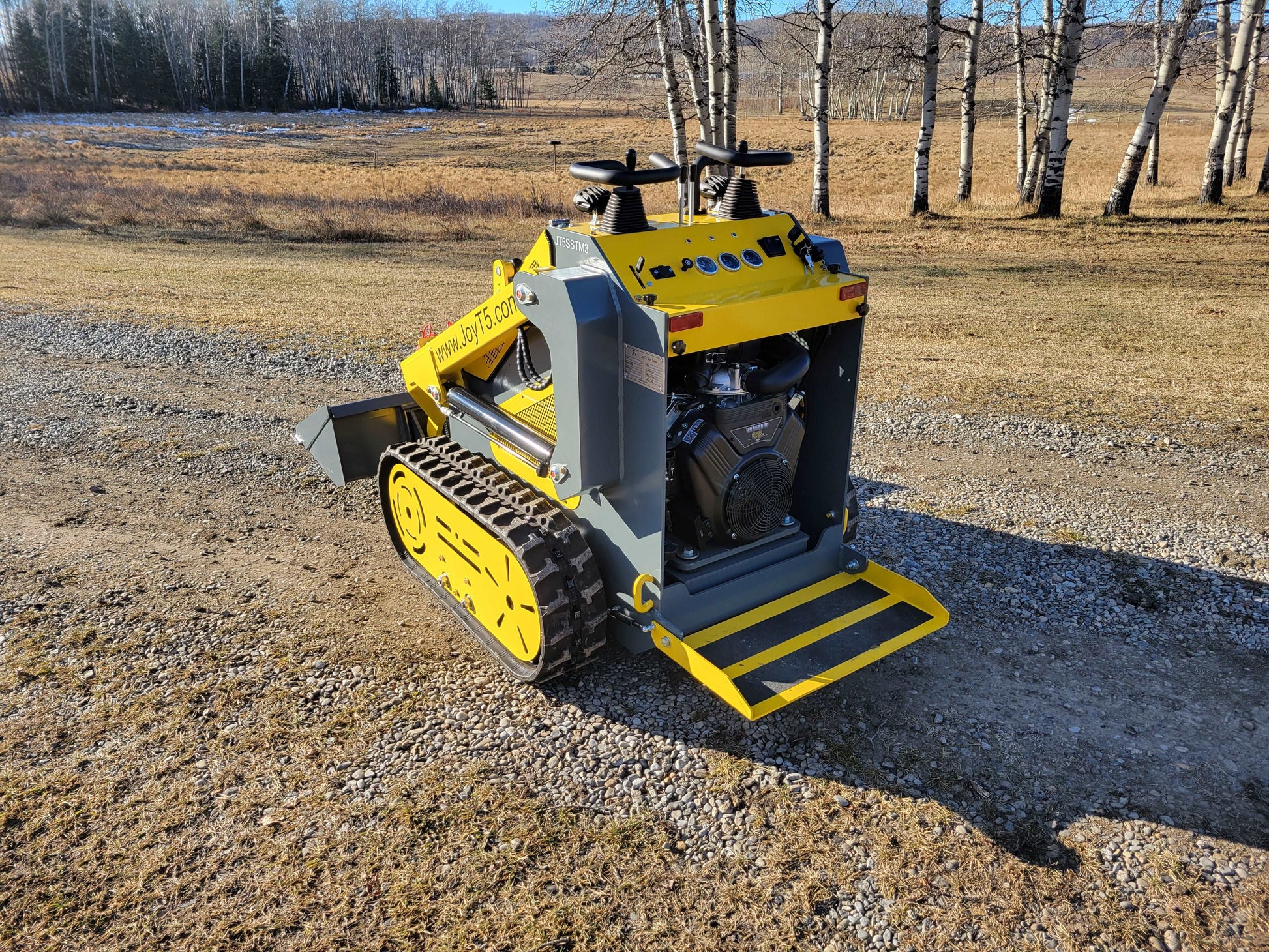 JoyT5 JT5SSTM3 mini tracked skid steer rear view showing engine compartment and stand on platform for construction and landscaping work in Canada
