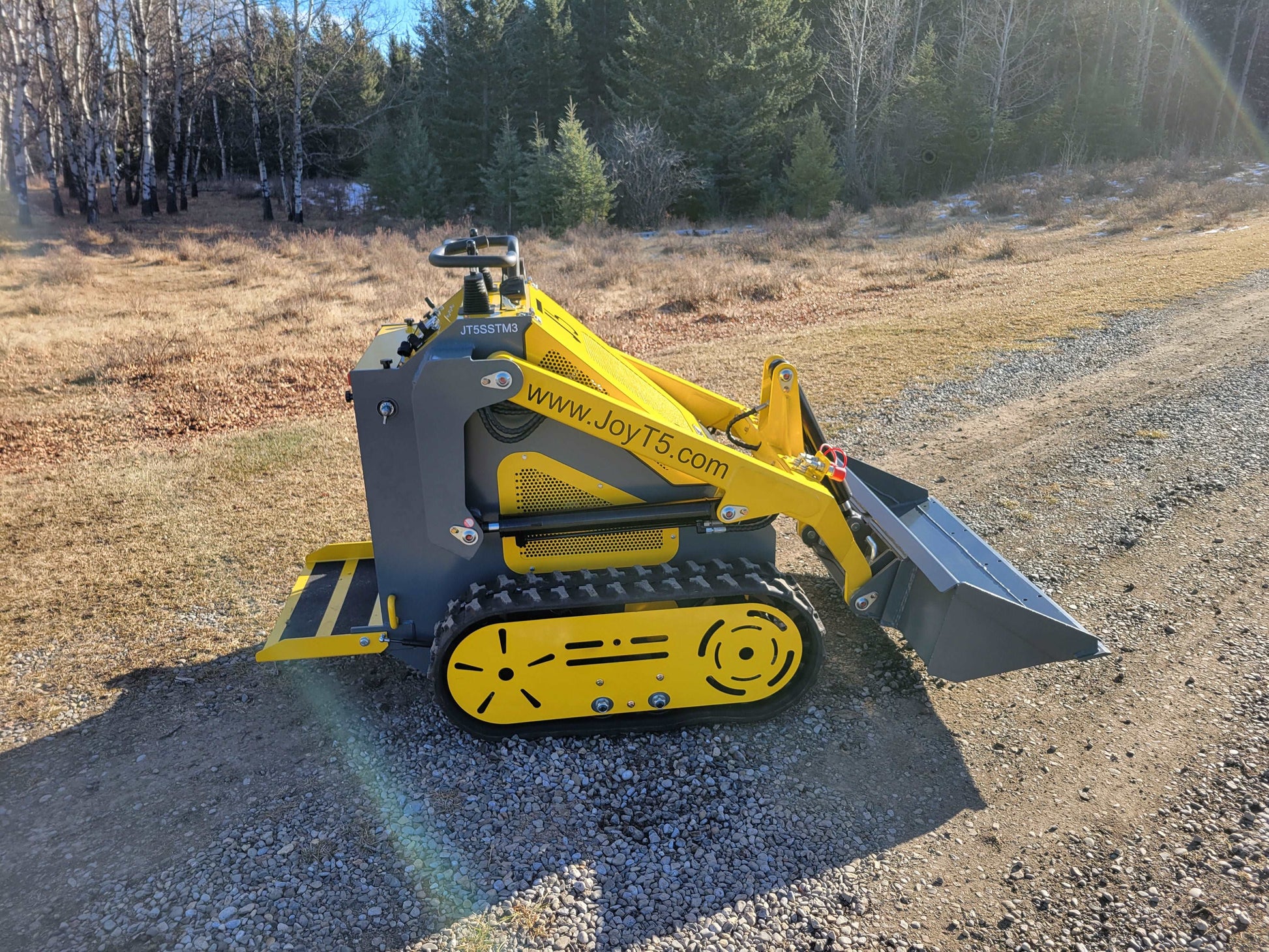 JoyT5 JT5SSTM3 mini tracked skid steer side profile with front bucket positioned for landscaping and construction tasks in Canada