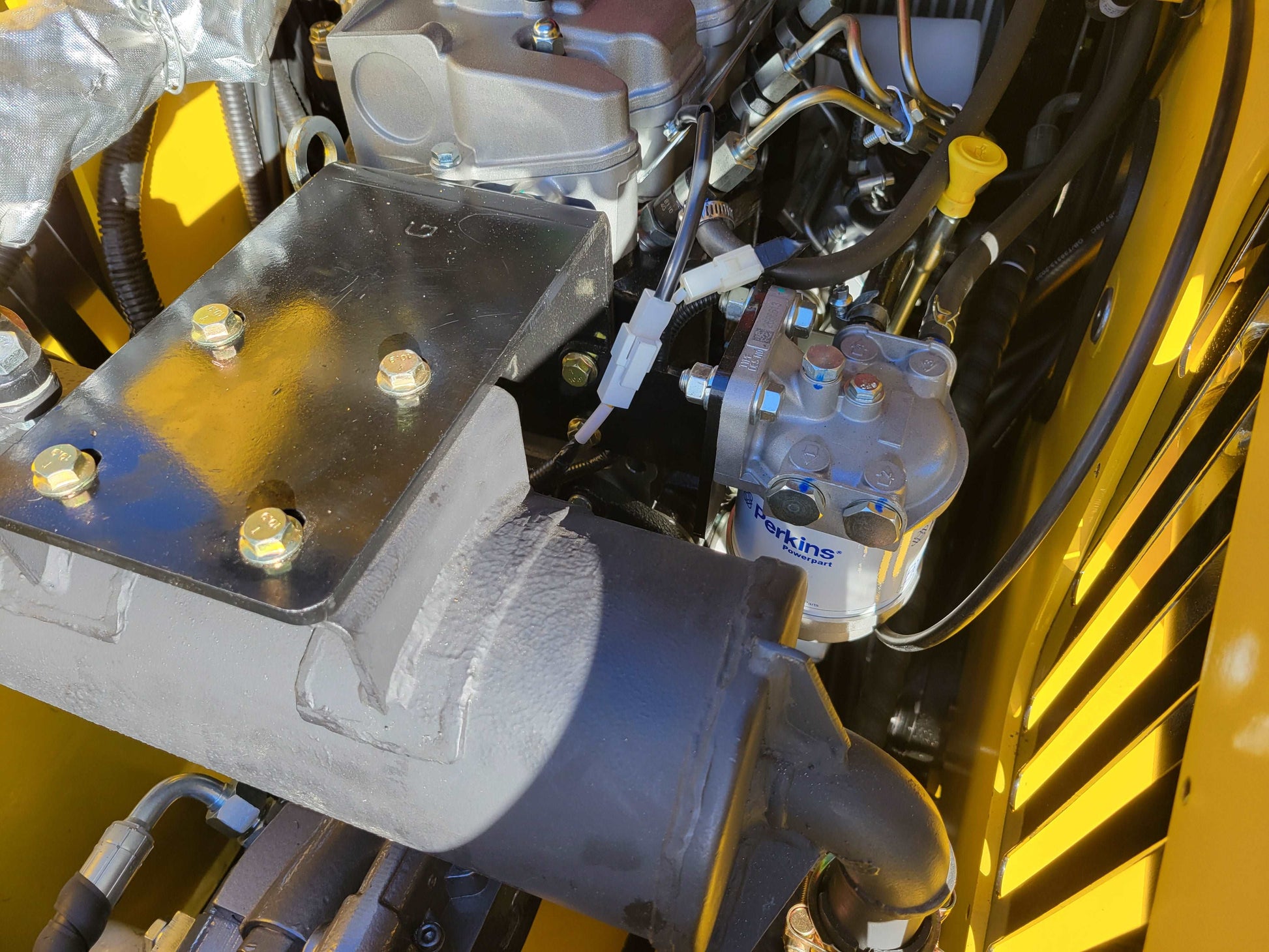 Perkins engine fuel filter and exhaust assembly inside JoyT5 JT5SSTM4 mini skid steer engine compartment.
