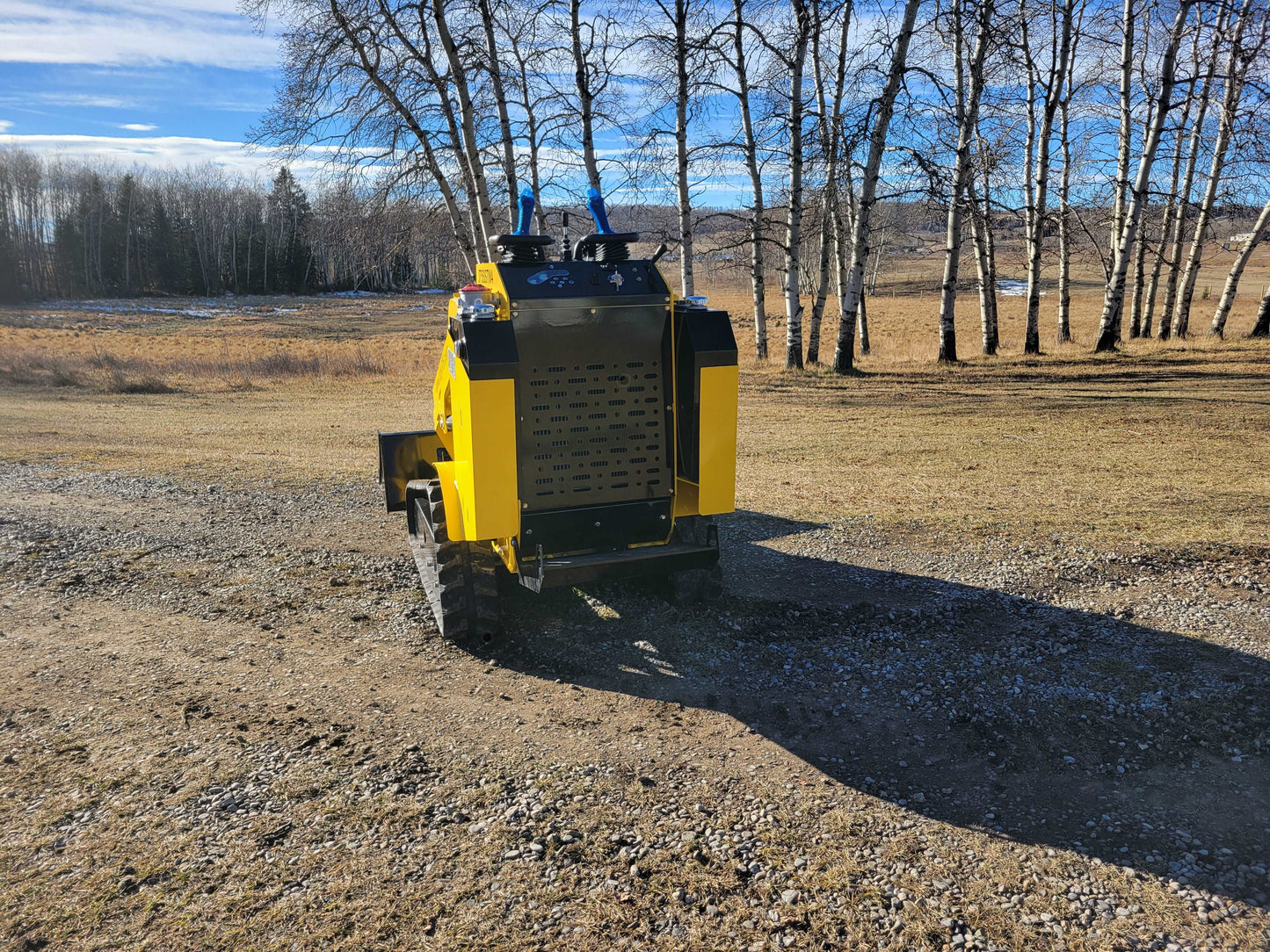 Rear view of JoyT5 JT5SSTM4 mini tracked skid steer loader, diesel-powered, 400kg lifting capacity, compact machine for farming and landscaping.