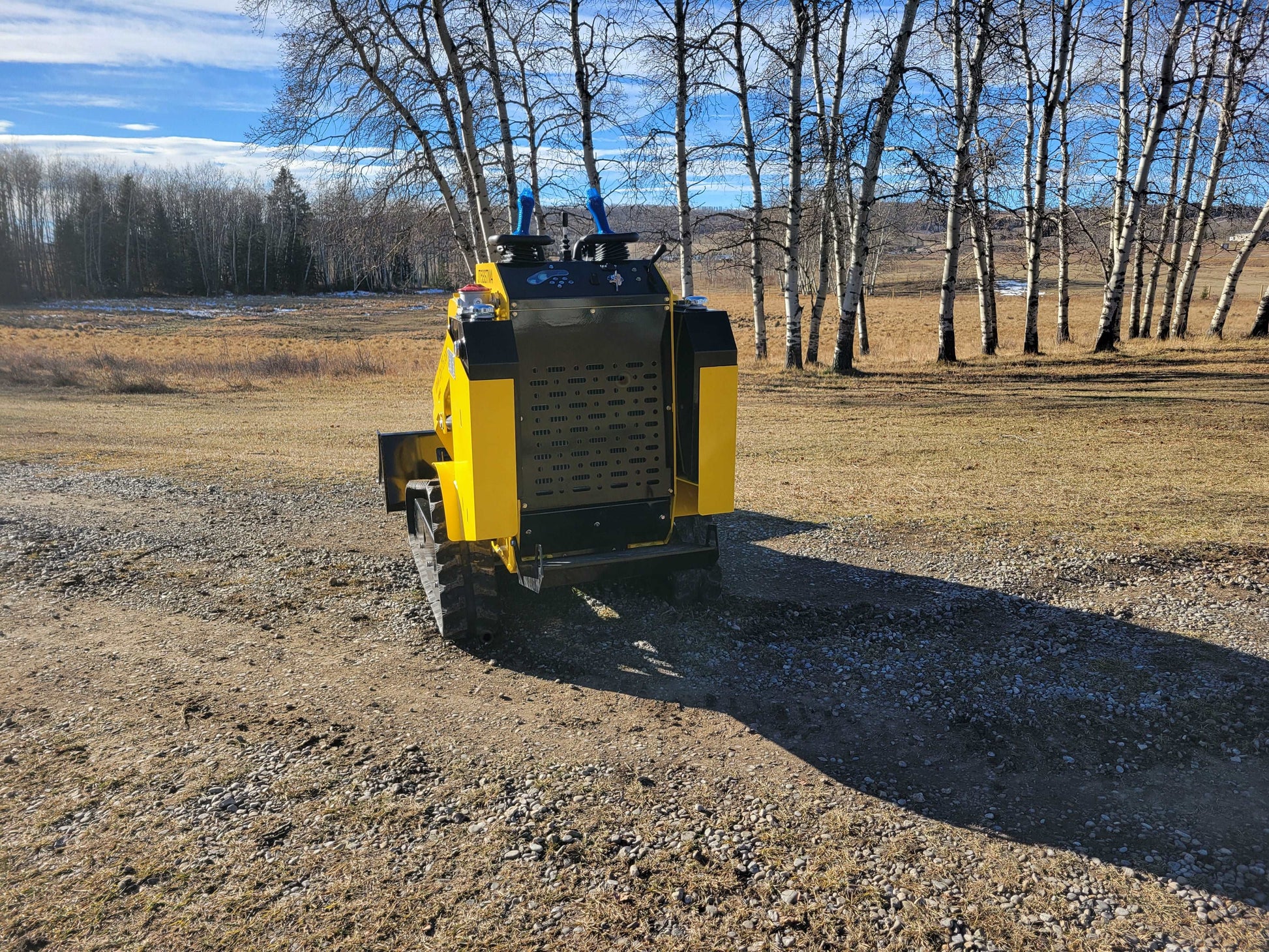 Rear view of JoyT5 JT5SSTM4 mini tracked skid steer loader, diesel-powered, 400kg lifting capacity, compact machine for farming and landscaping.