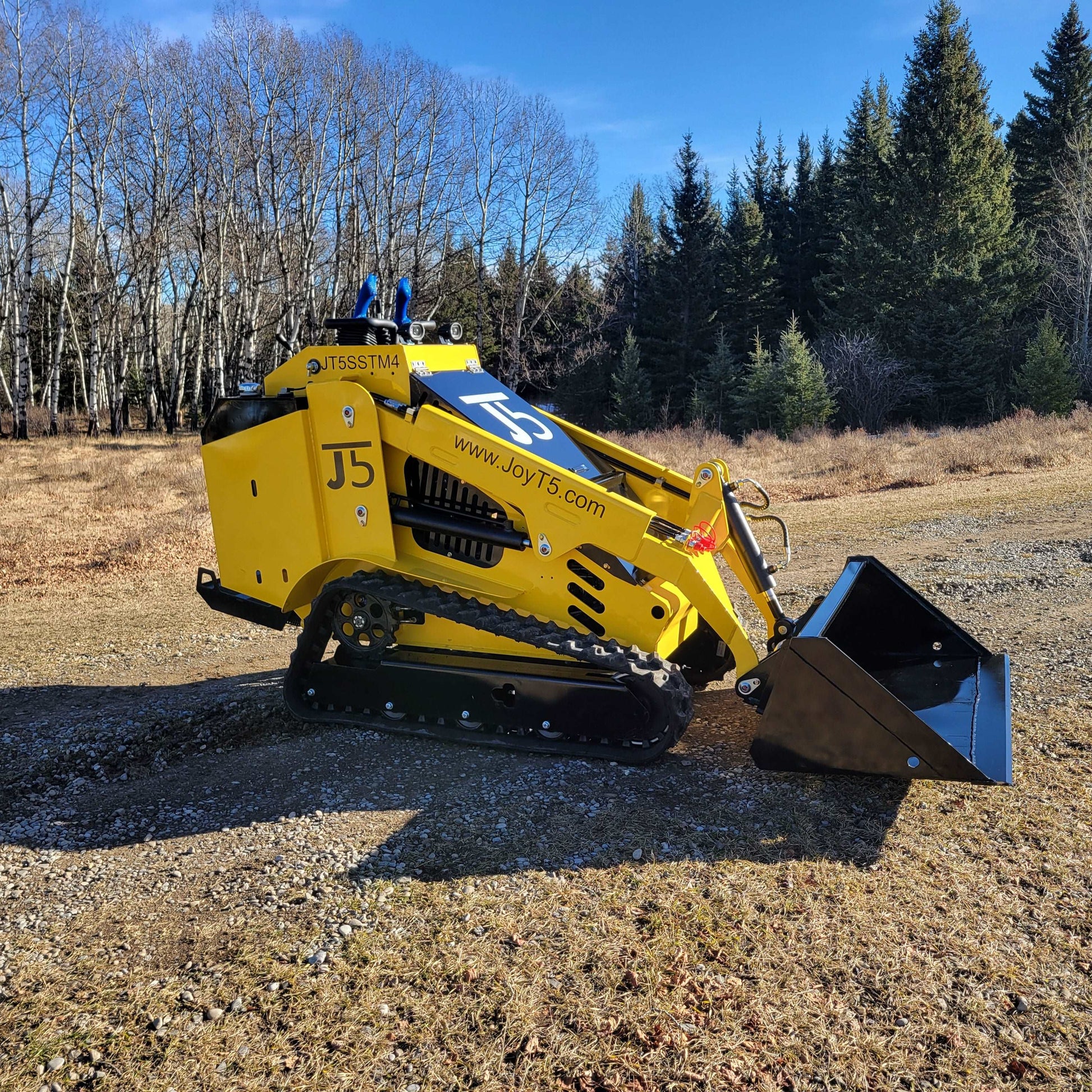 JoyT5 JT5SSTM4 tracked mini skid steer 25 HP in Canada shown in side working position with bucket on ground demonstrating diesel compact loader for construction landscaping and farming
