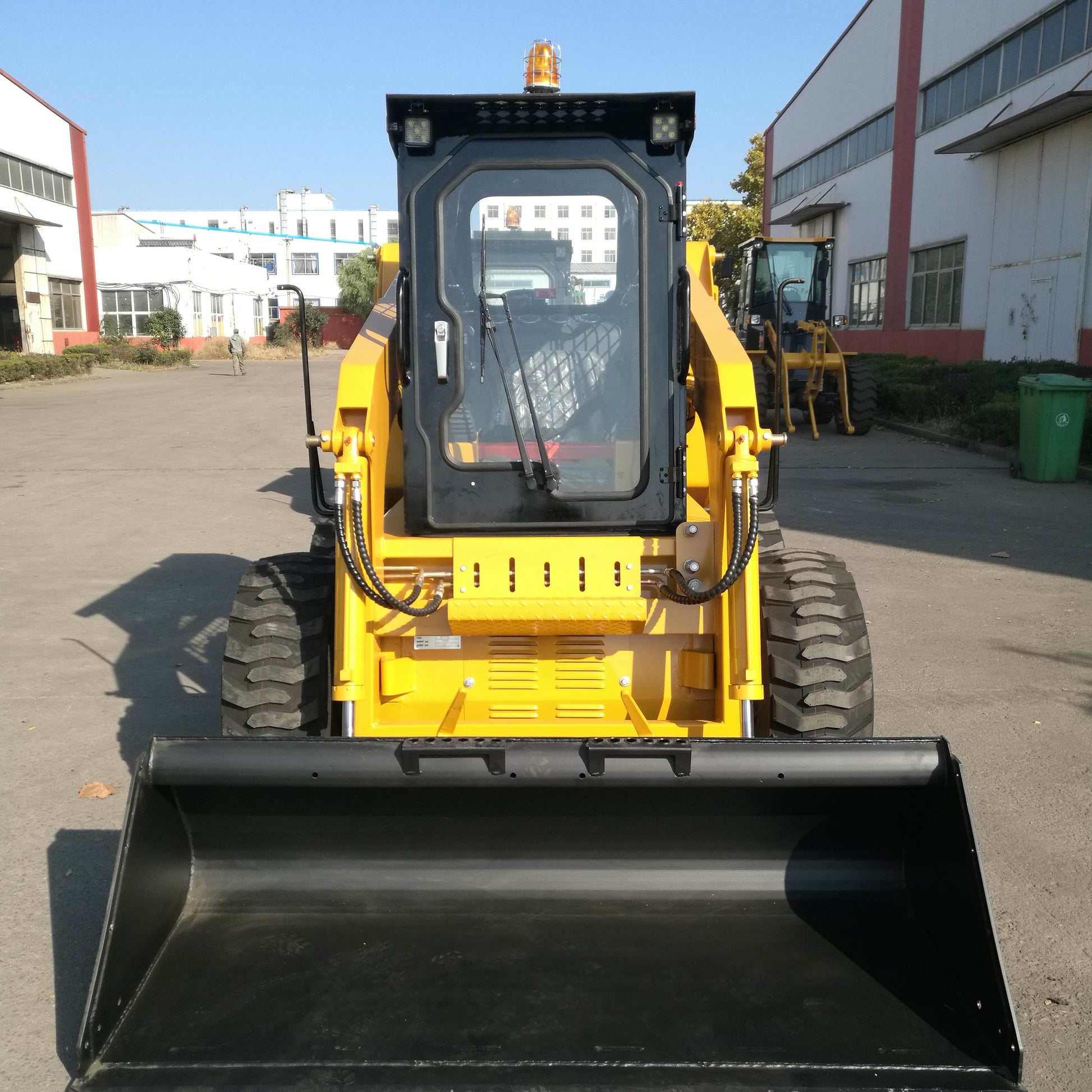 JoyT5 JT5SSW75 wheeled skid steer shown from front view with wide bucket attachment enclosed cab 73 HP engine and strong tires designed for construction and farming work in Canada
