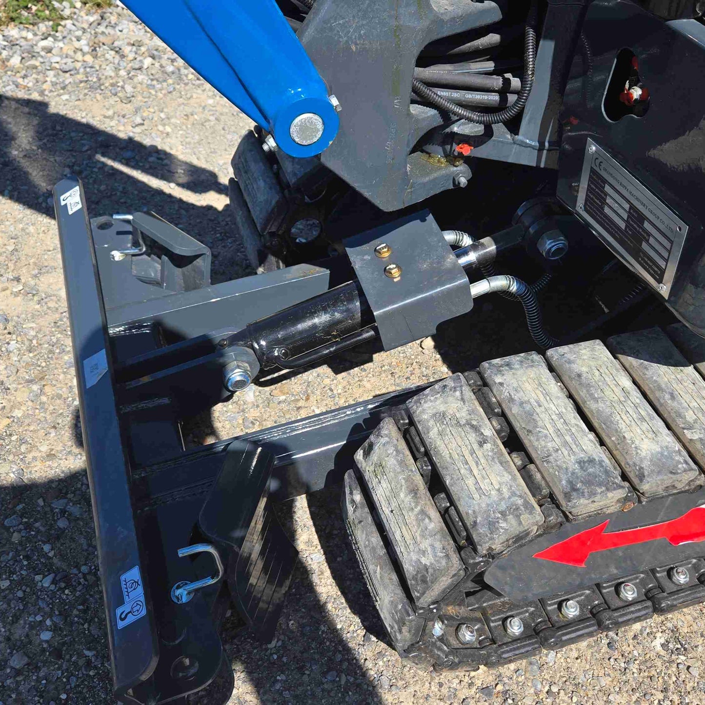 Close up view of JoyT5 mini excavator front dozer blade, hydraulic cylinder and rubber track system, showing strong build quality and precise control for grading, trench backfilling and landscaping work in Canada