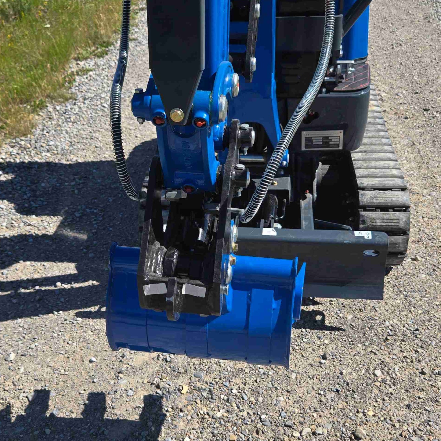 JoyT5 R13 mini excavator hydraulic quick coupler with digging bucket attached, designed for fast attachment changes on construction and landscaping projects in Canada