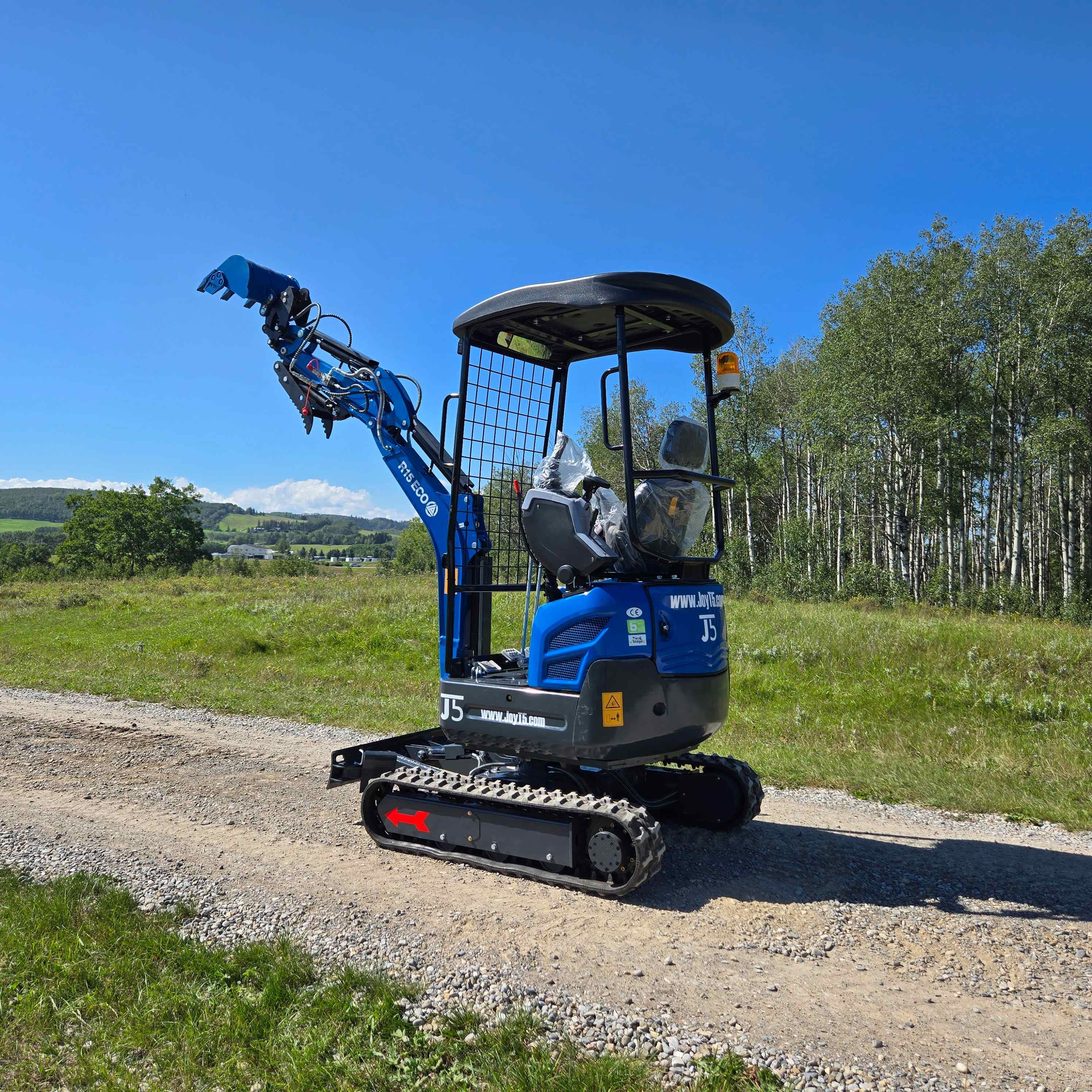 JoyT5 Rippa R15 1.5 ton mini excavator for sale in Canada compact digging machine powered by Kubota D722 engine shown on gravel road for landscaping residential excavation and small construction projects
