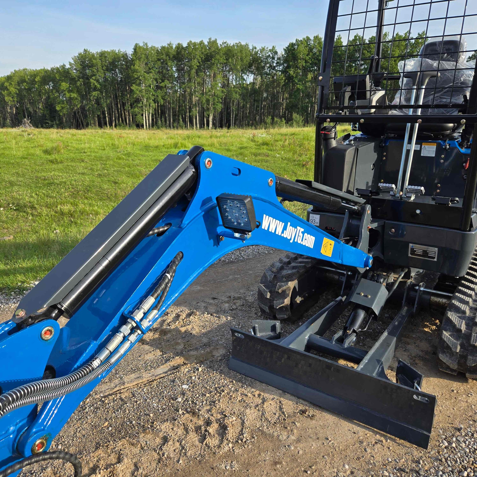 Close-up view of JoyT5 Rippa R18 Mini Excavator showing hydraulic arm, front blade, and operator cabin