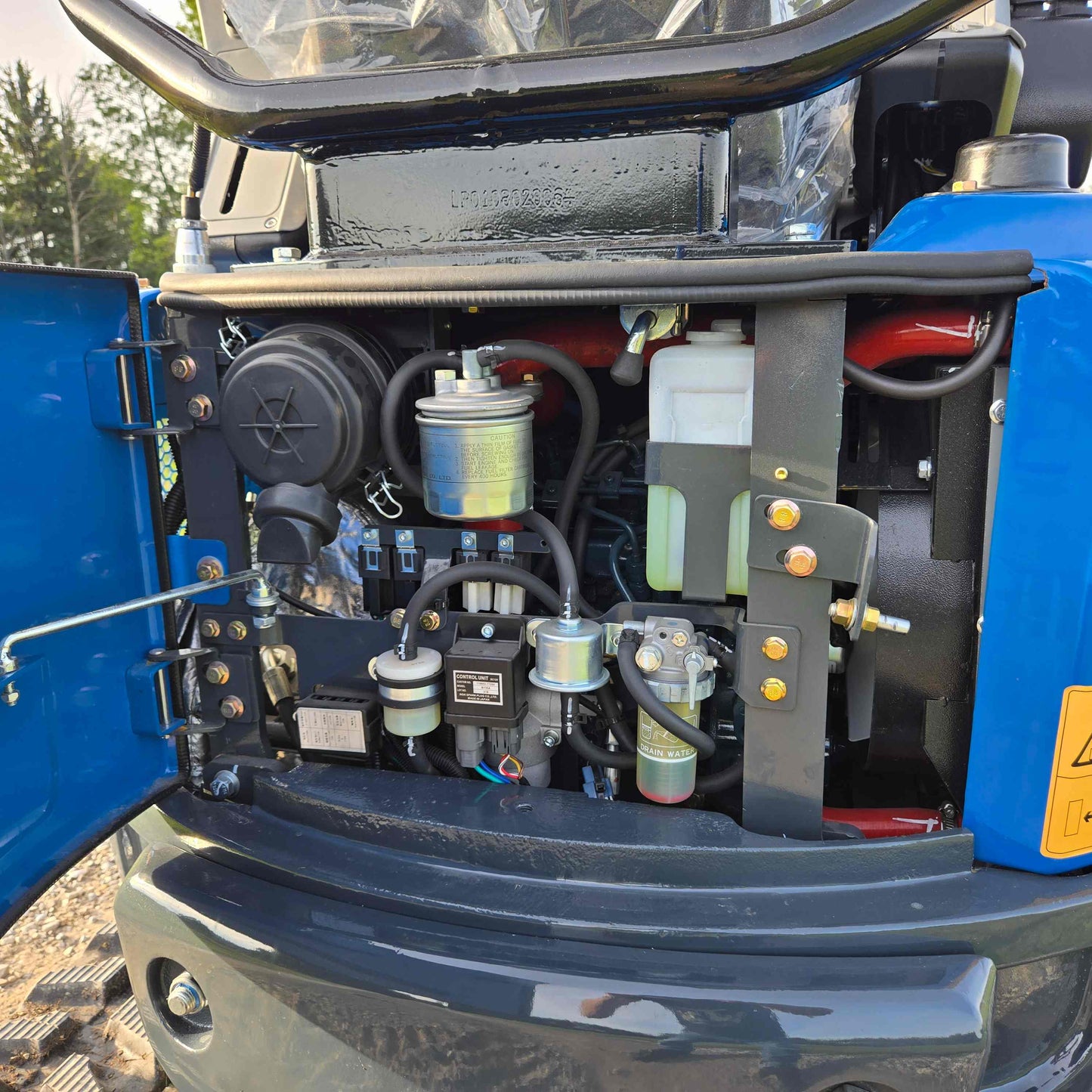 Engine compartment of JoyT5 Rippa R18 Mini Excavator showing fuel filter, hydraulic system and components