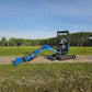 Front side view of JoyT5 Rippa R18 Mini Excavator with extended boom and digging bucket reaching the ground on a gravel path