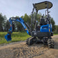 Side rear view of JoyT5 Rippa R18 Mini Excavator with digging bucket lowered and rubber tracks visible on gravel surface