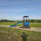 JoyT5 Rippa R18 Mini Excavator with bucket extended forward working on a dirt path in the field