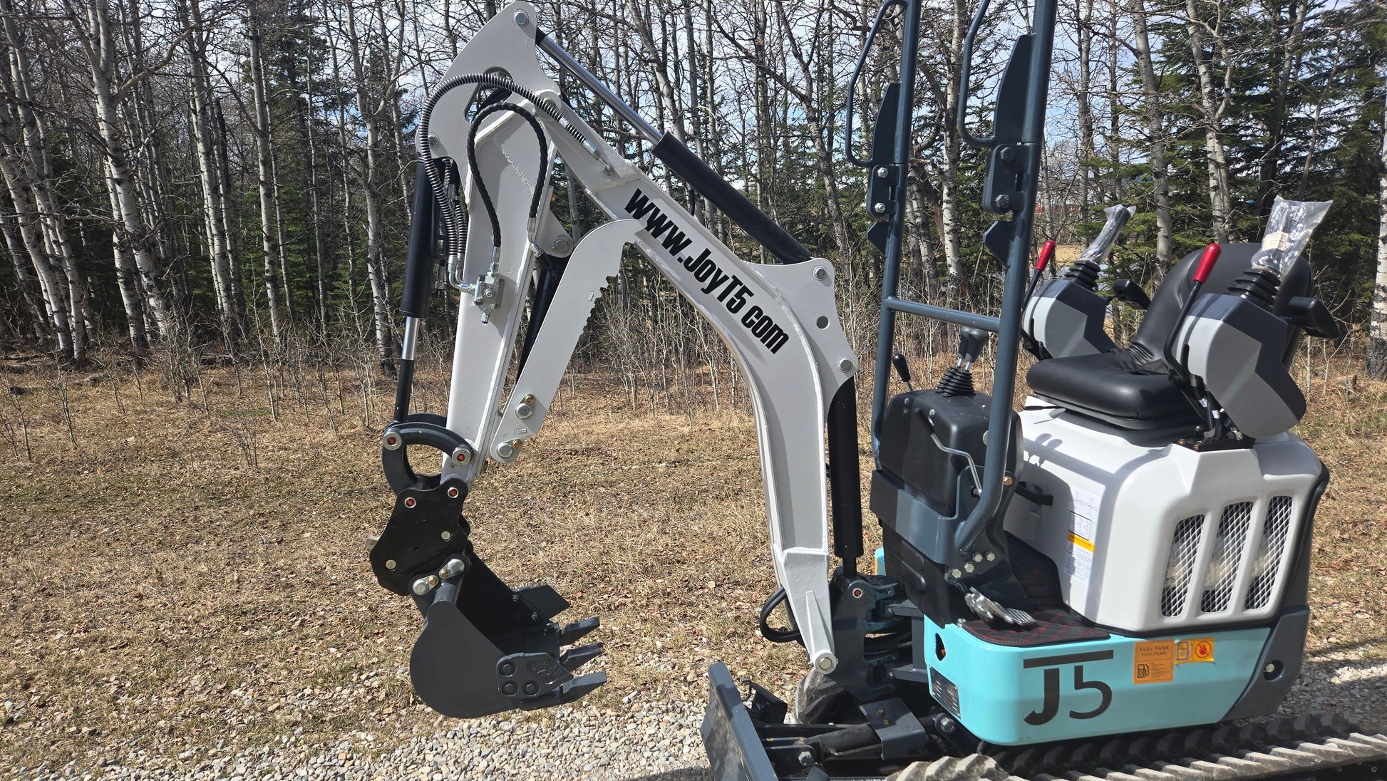 JT5120P 1.2 Ton mini excavator side view showing boom arm, digging bucket and operator seat with dual joystick controls.
