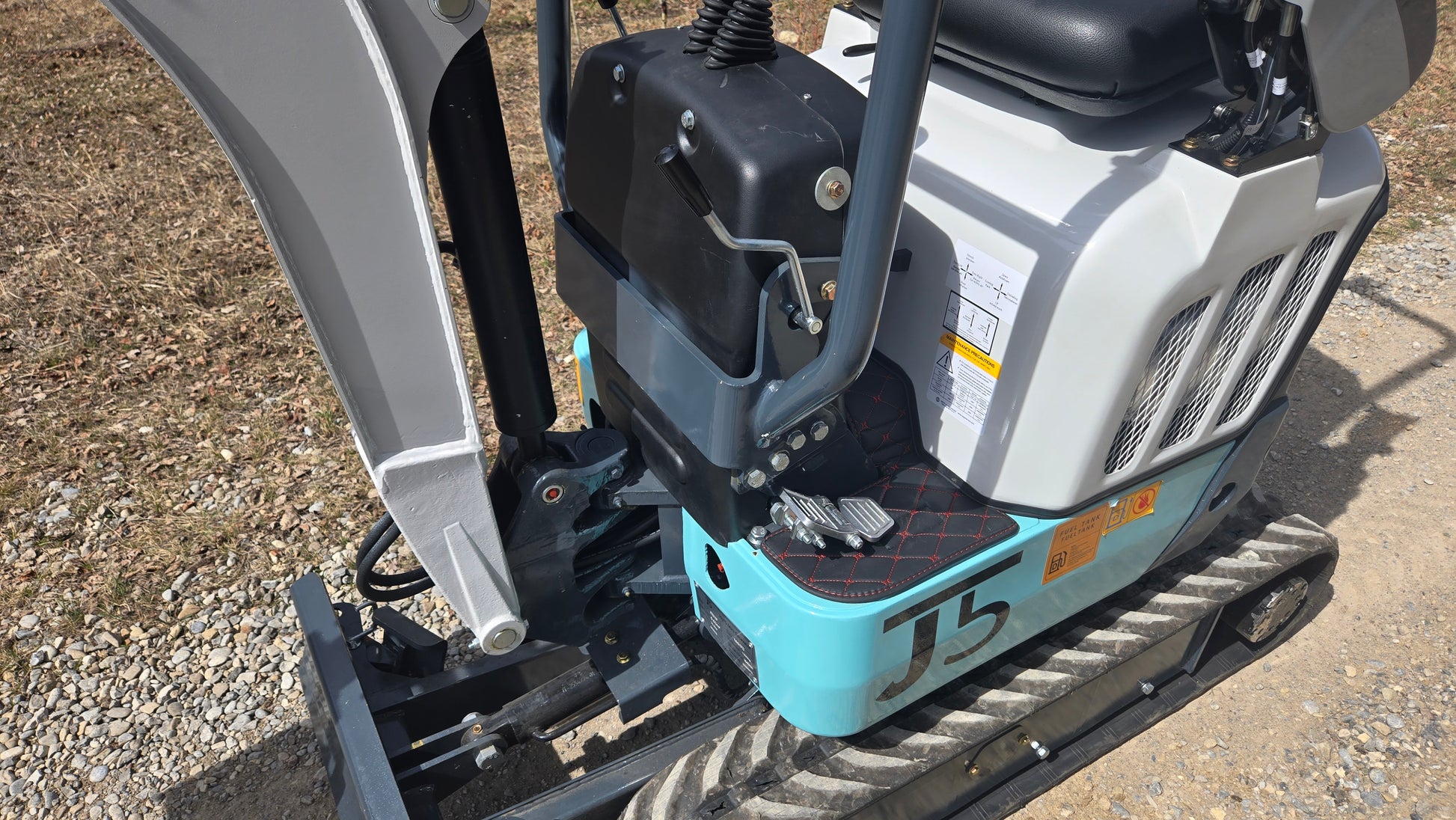 JT5120P 1.2 Ton mini excavator detailed side view showing operator foot pedals and hydraulic system for precise control on construction sites.
