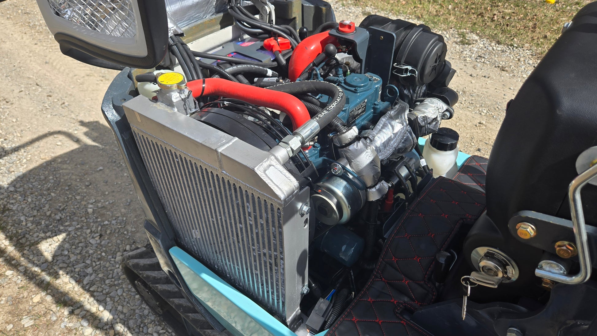 JT5120P mini excavator engine and radiator system with cooling hoses and components.
