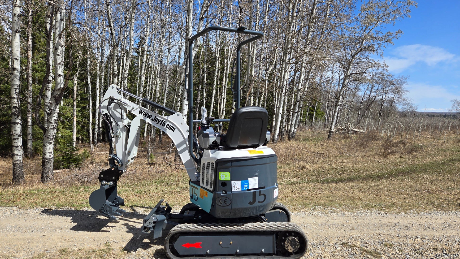 JT5120P zero tail mini excavator side view working beside forest trail in Canada with JoyT5 support for compact digging projects