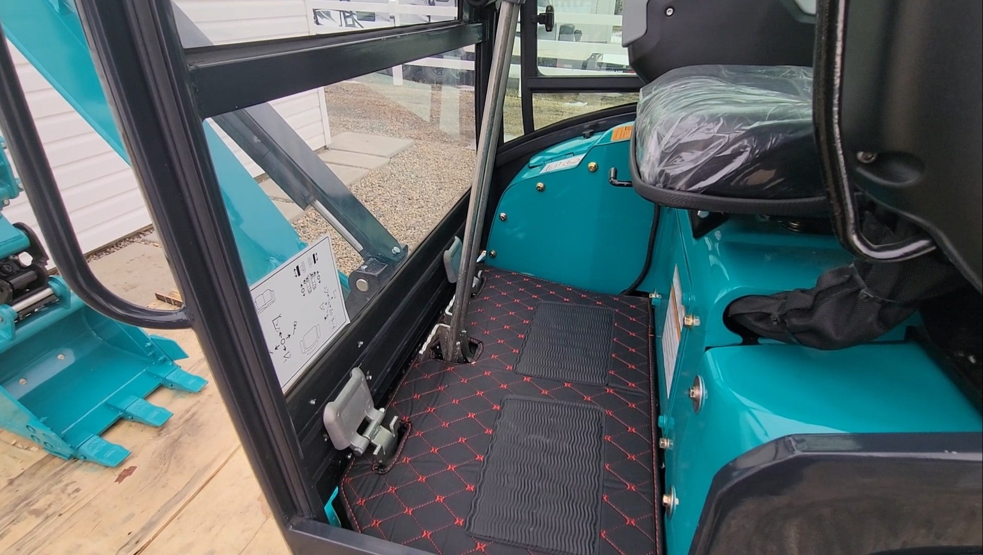 JT5200 Special Edition 2 Ton Mini Excavator cabin with comfortable seat, floor mat, and ergonomic controls – compact 4400 lbs digger with Kubota engine for landscaping and construction.