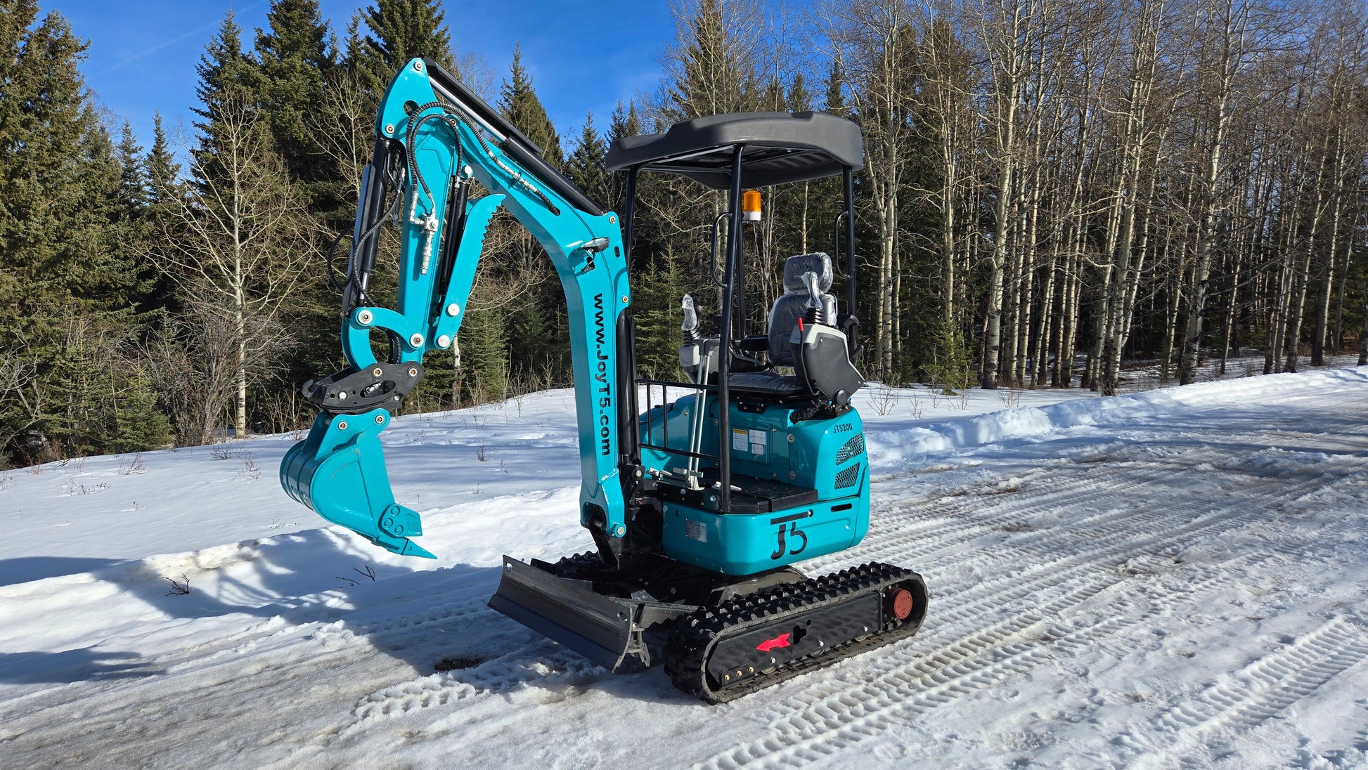 JT5200 2 Ton Mini Excavator for Sale in Canada JoyT5 compact zero tail excavator working on snowy forest jobsite with hydraulic blade ideal for landscaping and construction projects in Canada
