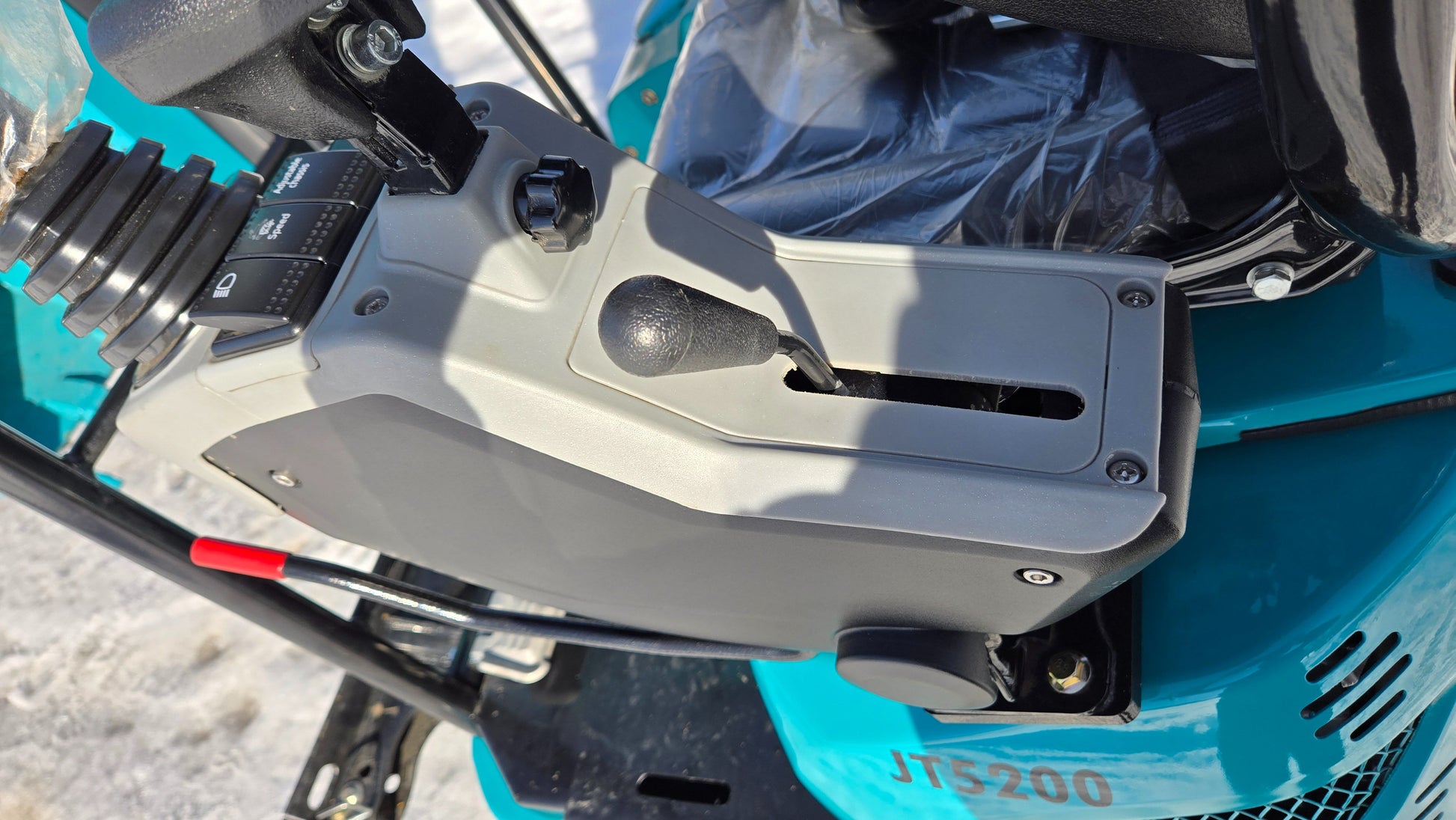 Close-up of control lever and side panel with switches on JoyT5 JT5200 2 ton mini excavator, showing ergonomic operator controls.
